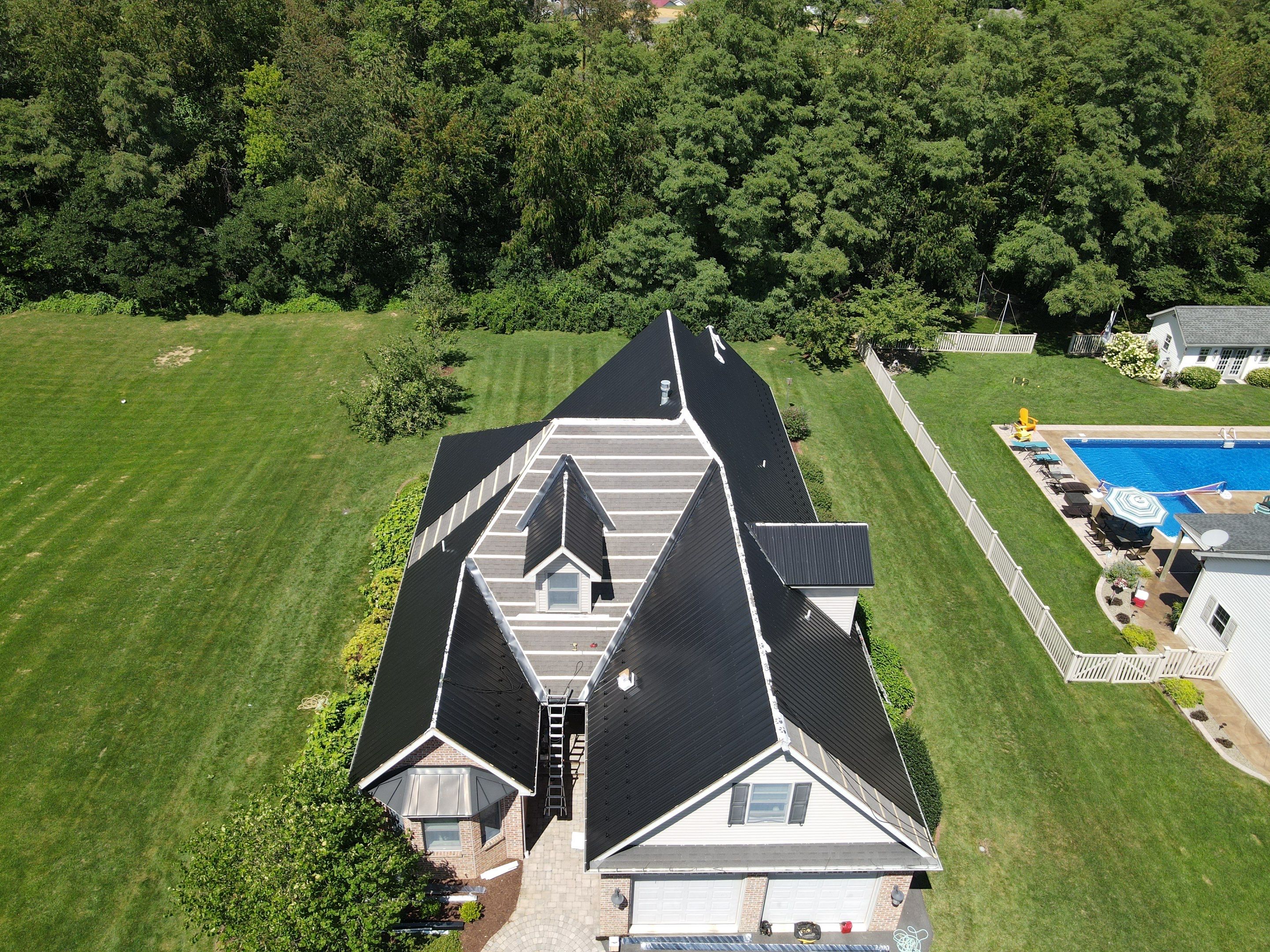 Standing seam / Azm panel in black  by Teflon Roofing
