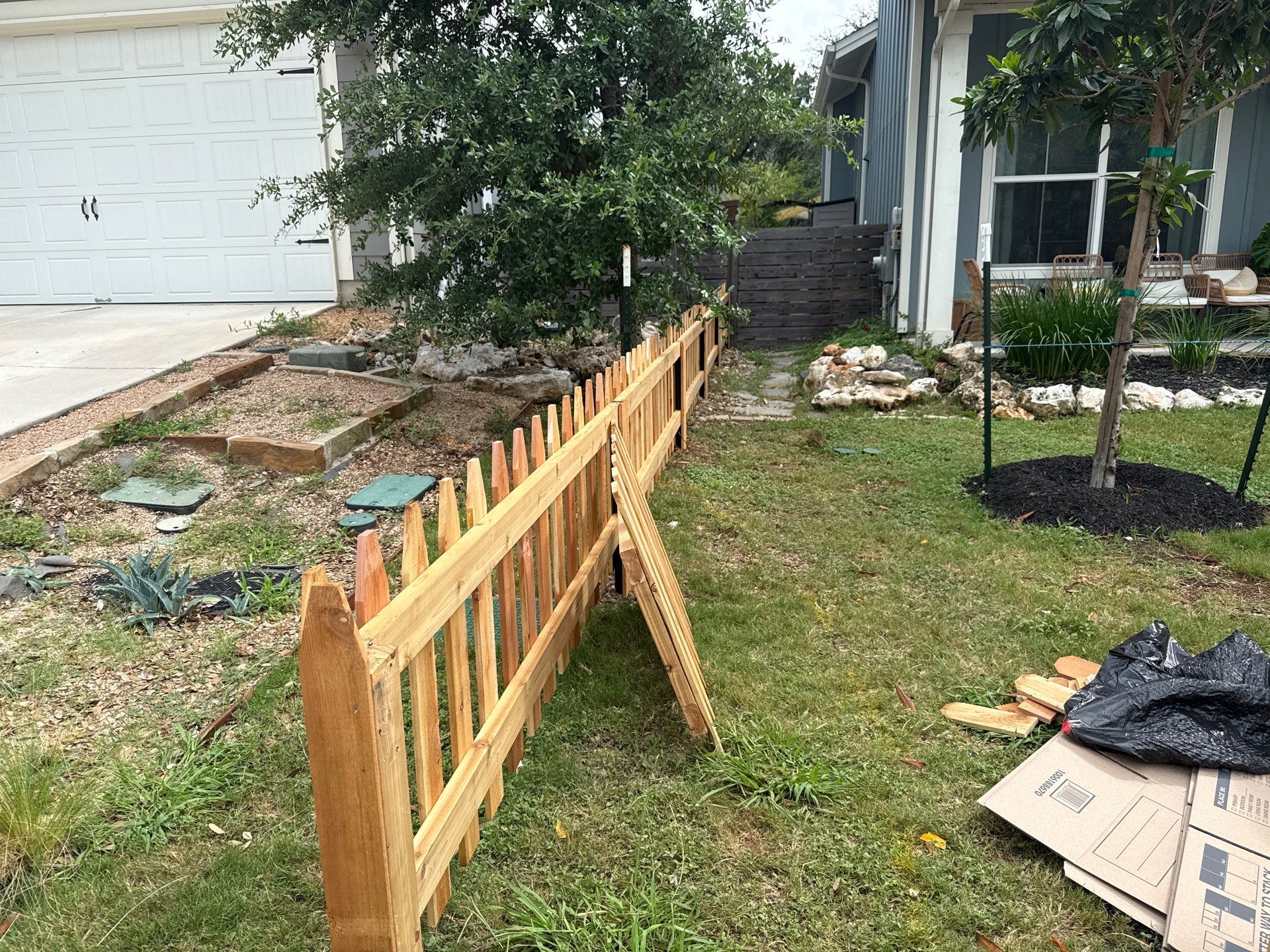Austin Residential Wooden Picket Fence Installation and Solid Color Staining by Rhino Home Care