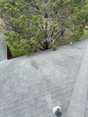 Architectural asphalt shingle roof with a plumbing vent pipe.