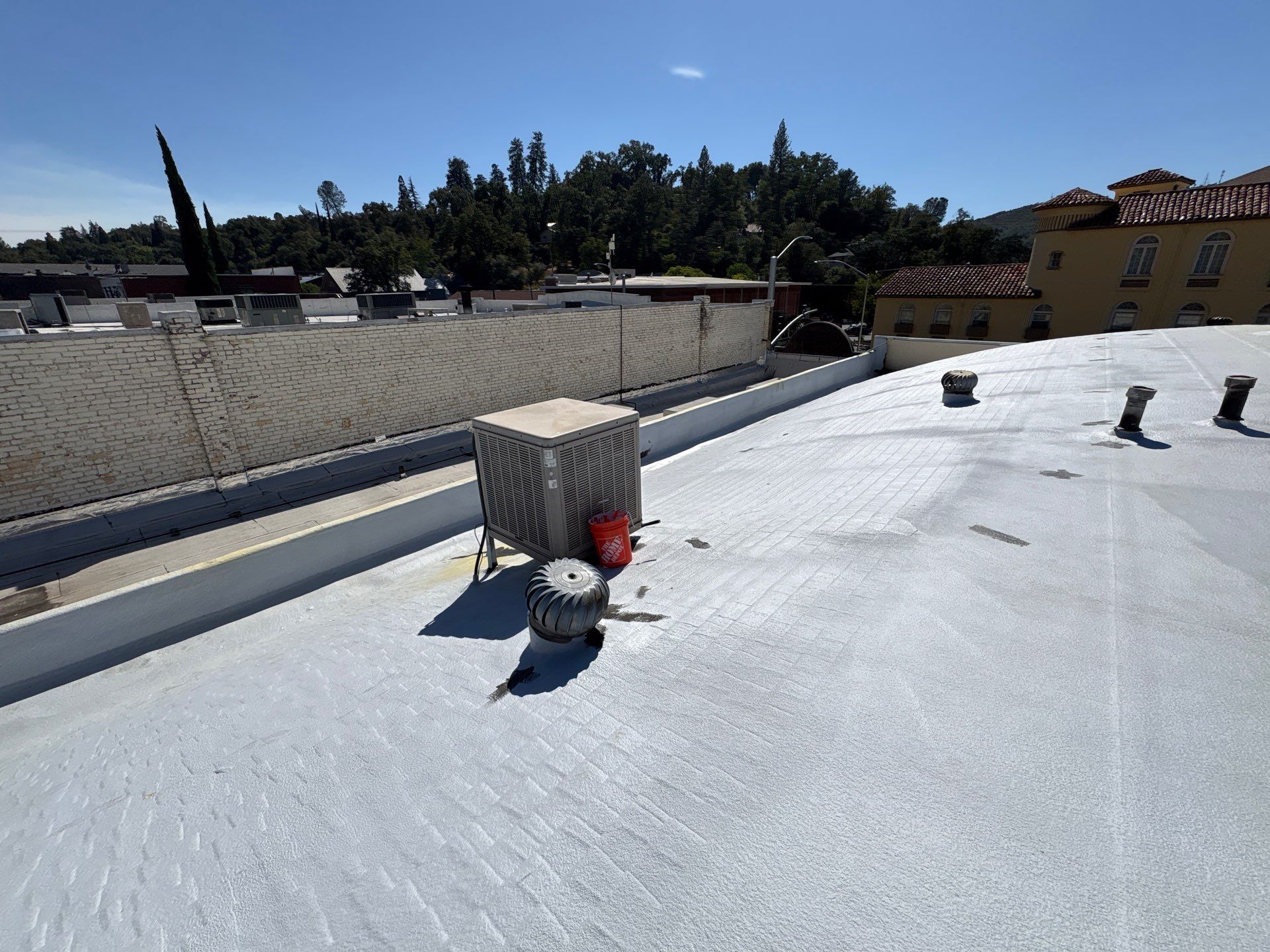 Foam and coatings on commercial roof by Straight Edge Roofing Inc