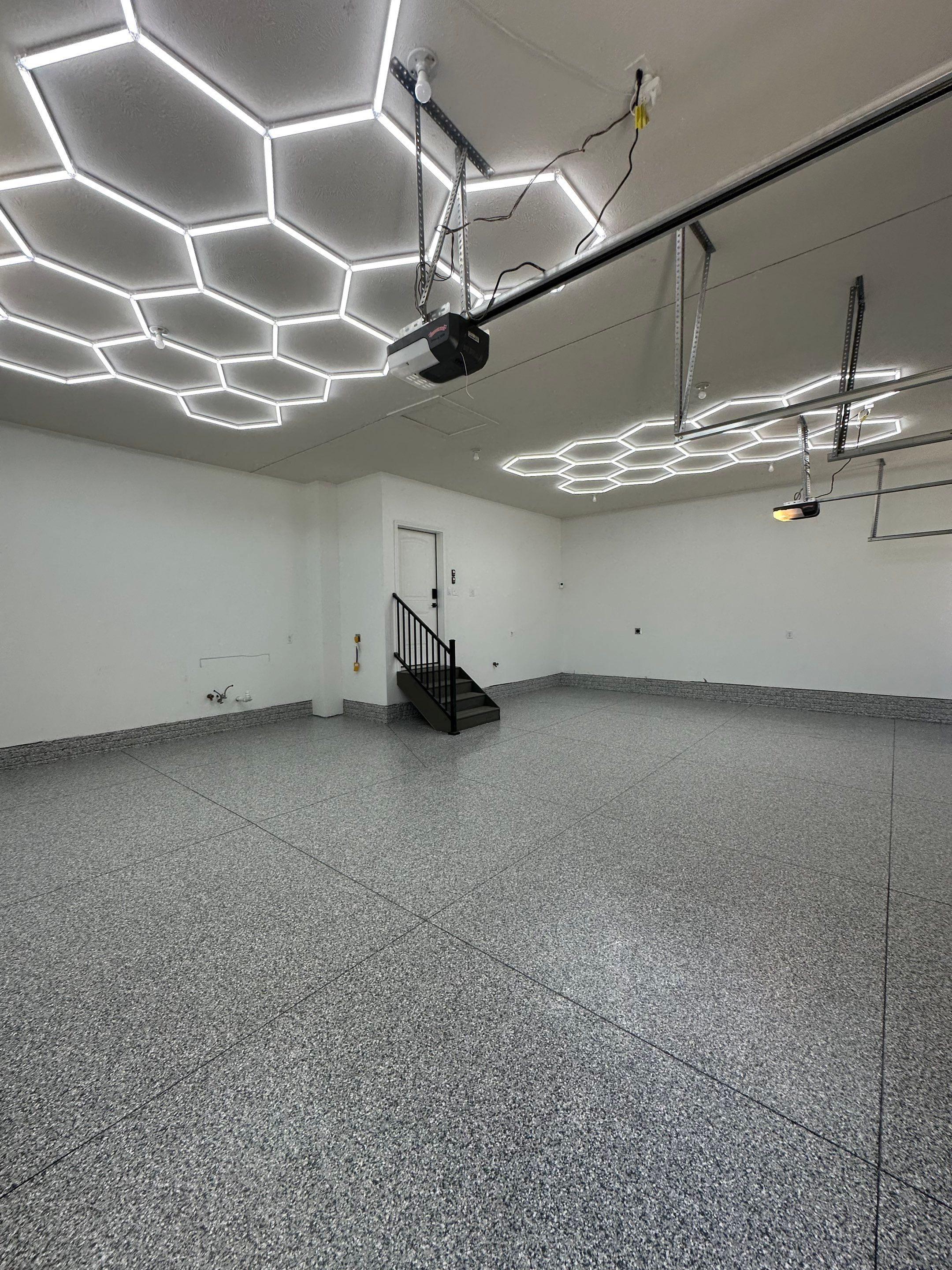 Three-Stall Garage Epoxy Floor Coating and LED Lighting in Lincoln by Goat Coatings