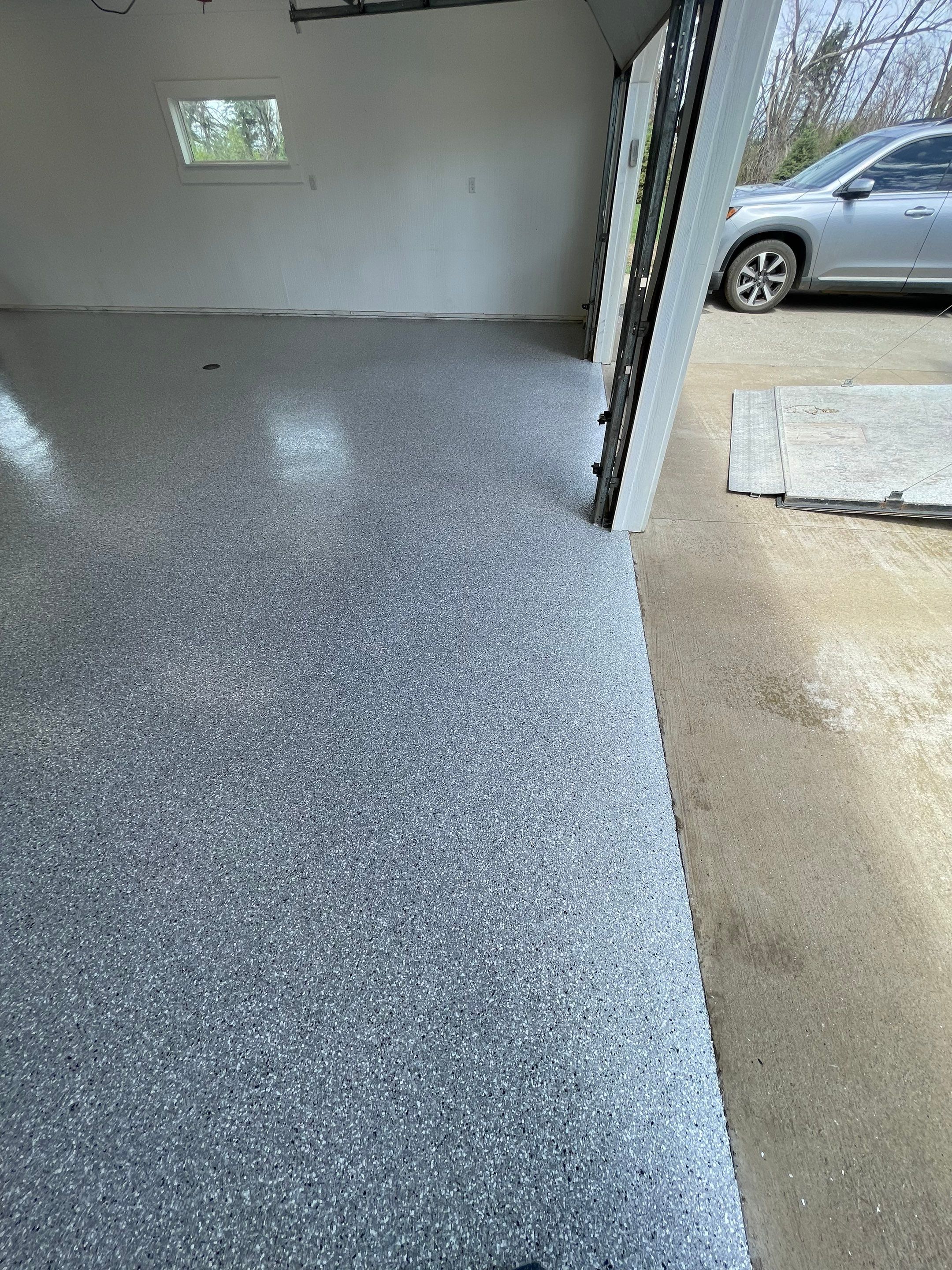 Feather Grey Garage Floor Coating and Crack Repair in Beresford by Select Painting, Coatings & Garage Cabinets