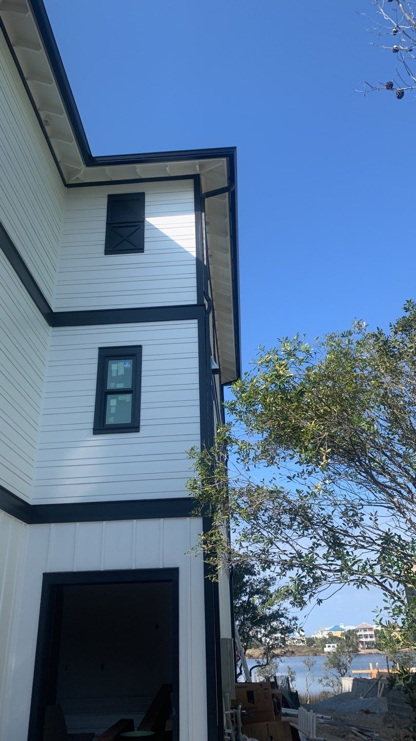 Seamless Gutter Installation Using Black Half Round Seamless Gutters by Gutter Professors