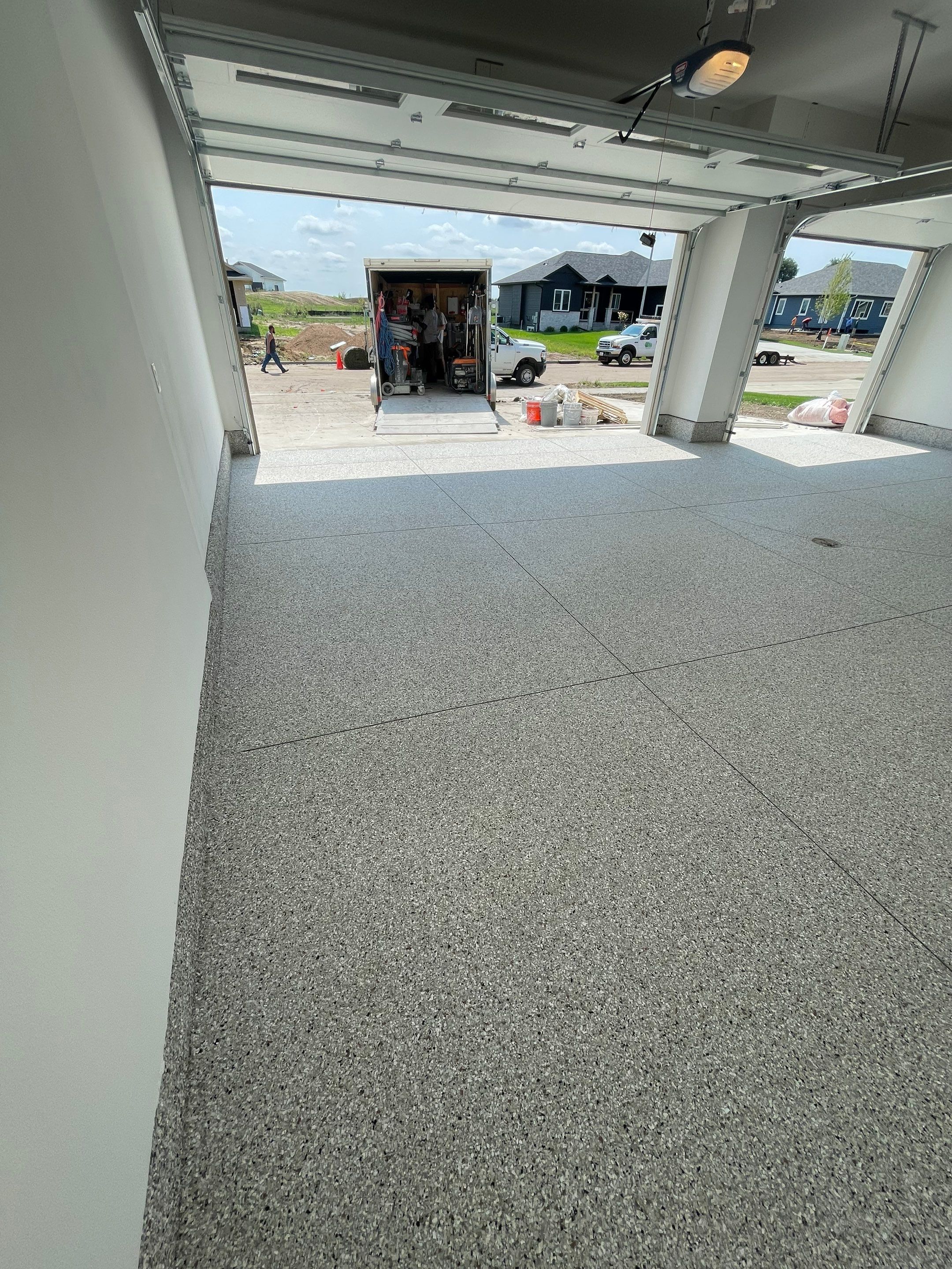 Grey Speckled Garage Floor Coating in Sioux Falls by Select Painting, Coatings & Garage Cabinets