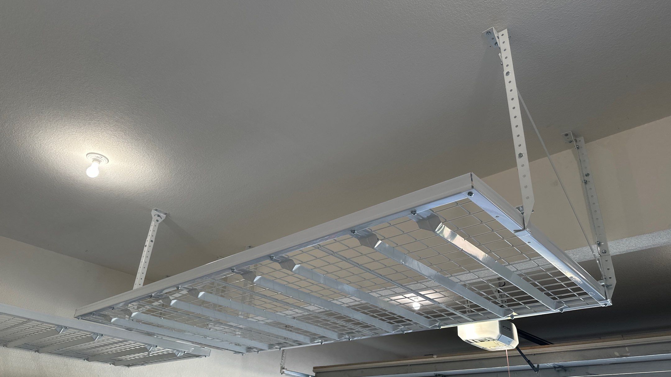 Darlene maximized their storage with overhead racks.  by Banner Garage