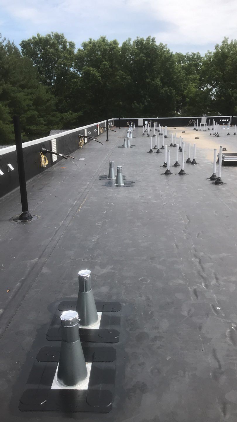 Commercial Roofing Installation using EPDM with white gutters by A Plus Exterior