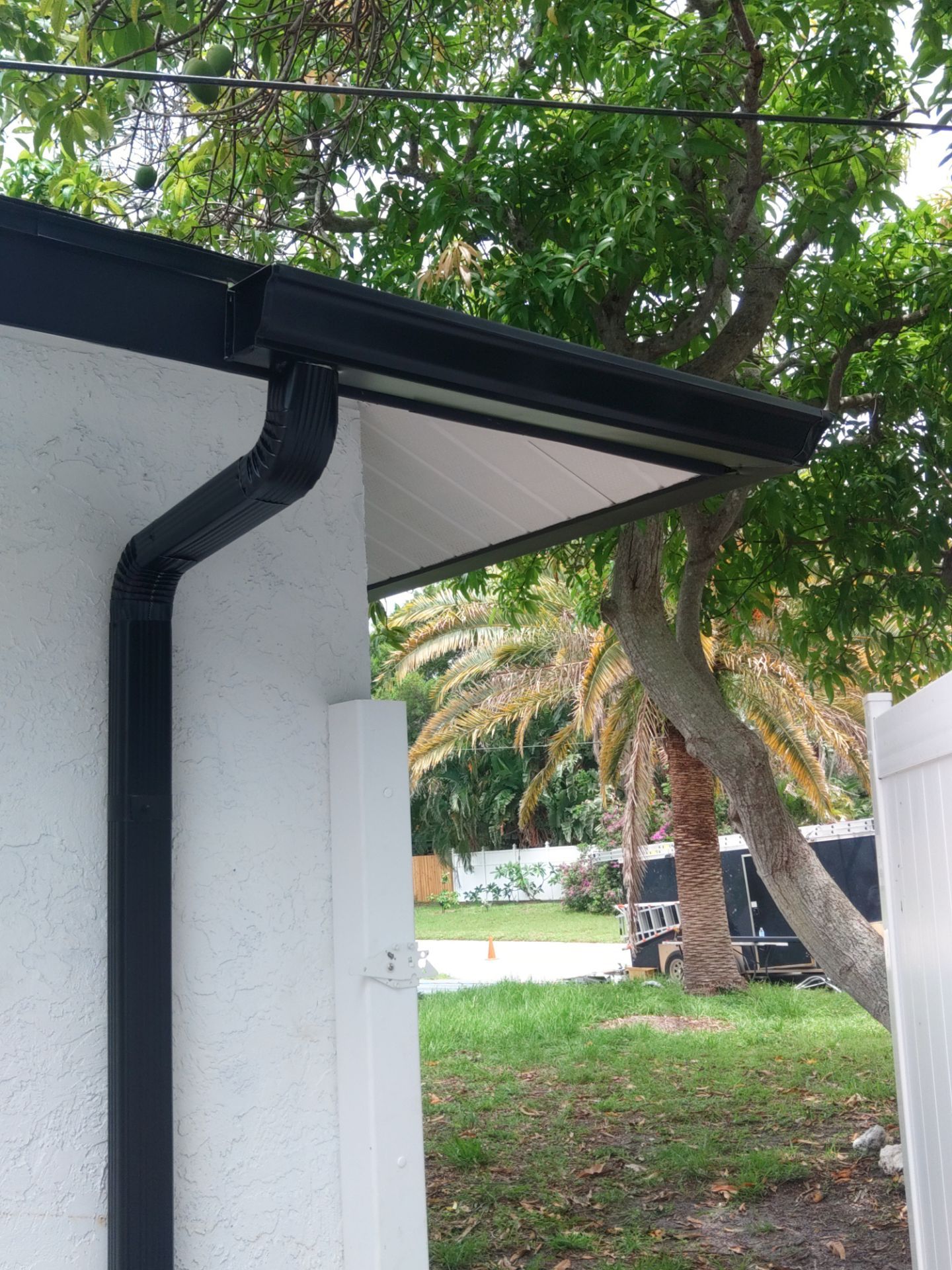 Black seamless gutters and downspouts installation in Sarasota, FL by Gutter Professors