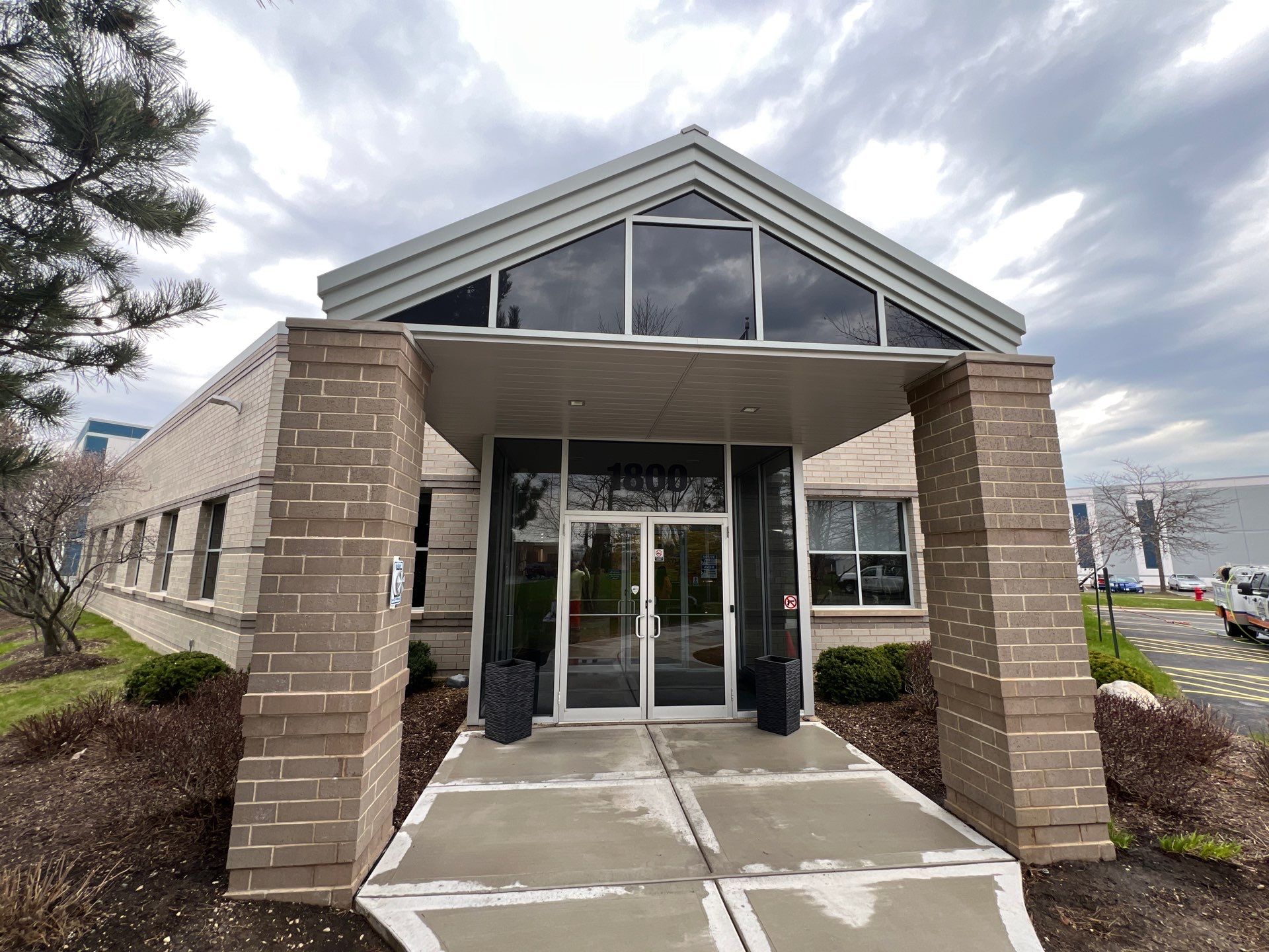 Commercial Facade cleaning using Algaecide, soft wash soap by Northern Power Washing LLC.