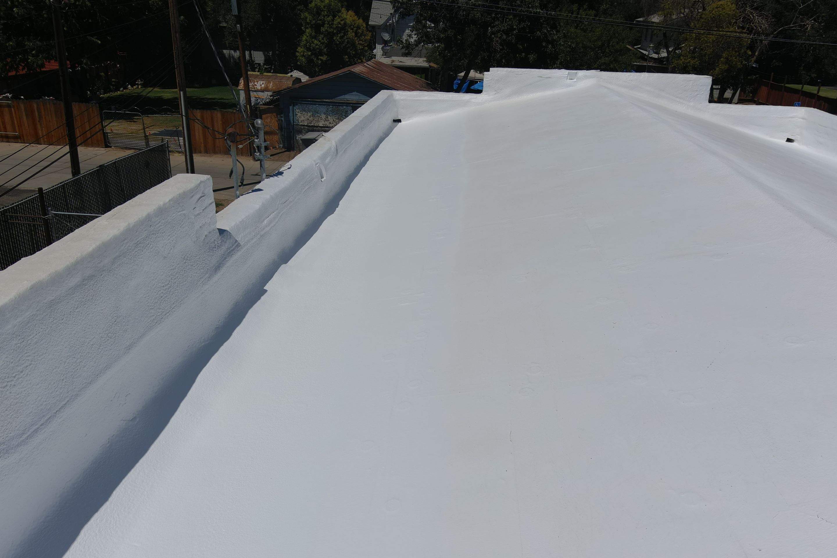 Commercial Roofing Installation using Conklin BenchPly system with PUMA top coat (imbedded fabric system) by Straight Edge Roofing Inc