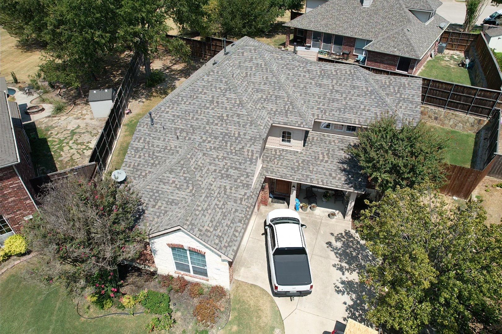 Red brick/white stone with IKO Cornerstone by Tejas Roofworks + Restoration