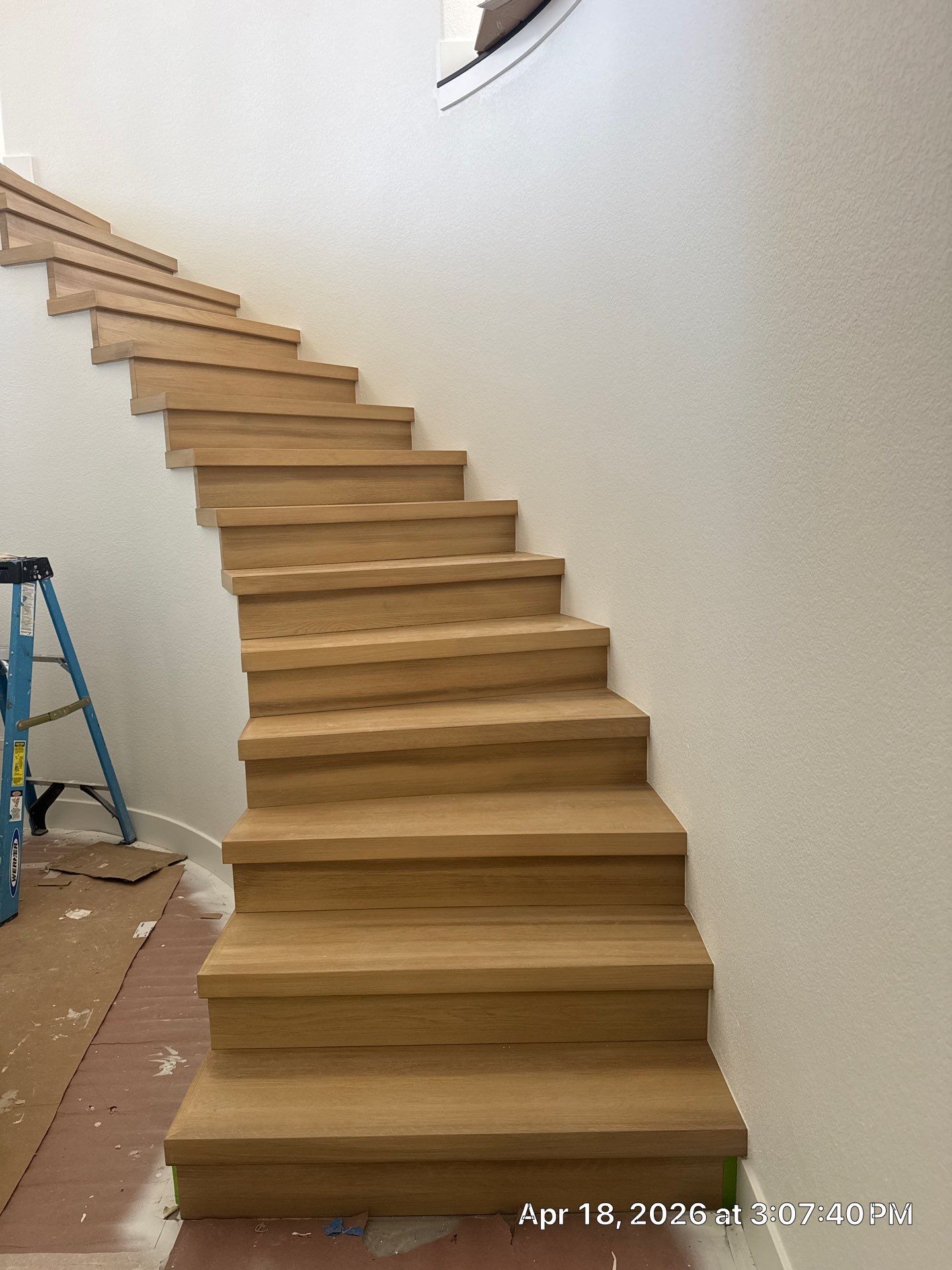 Curved Oak Staircase and Custom Metal Railing Installation in Lone Tree by LP Construction Services