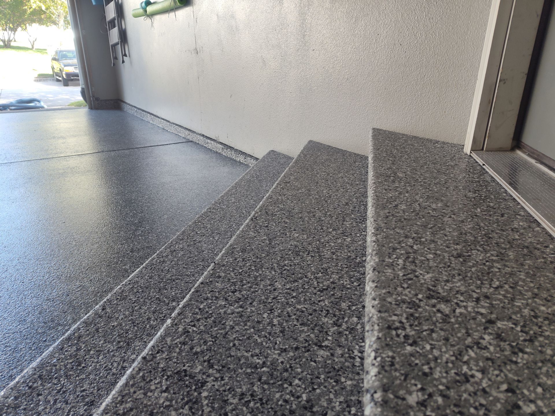 Close Up View of This Customer's New Flake Coating by Revival Concrete Coatings