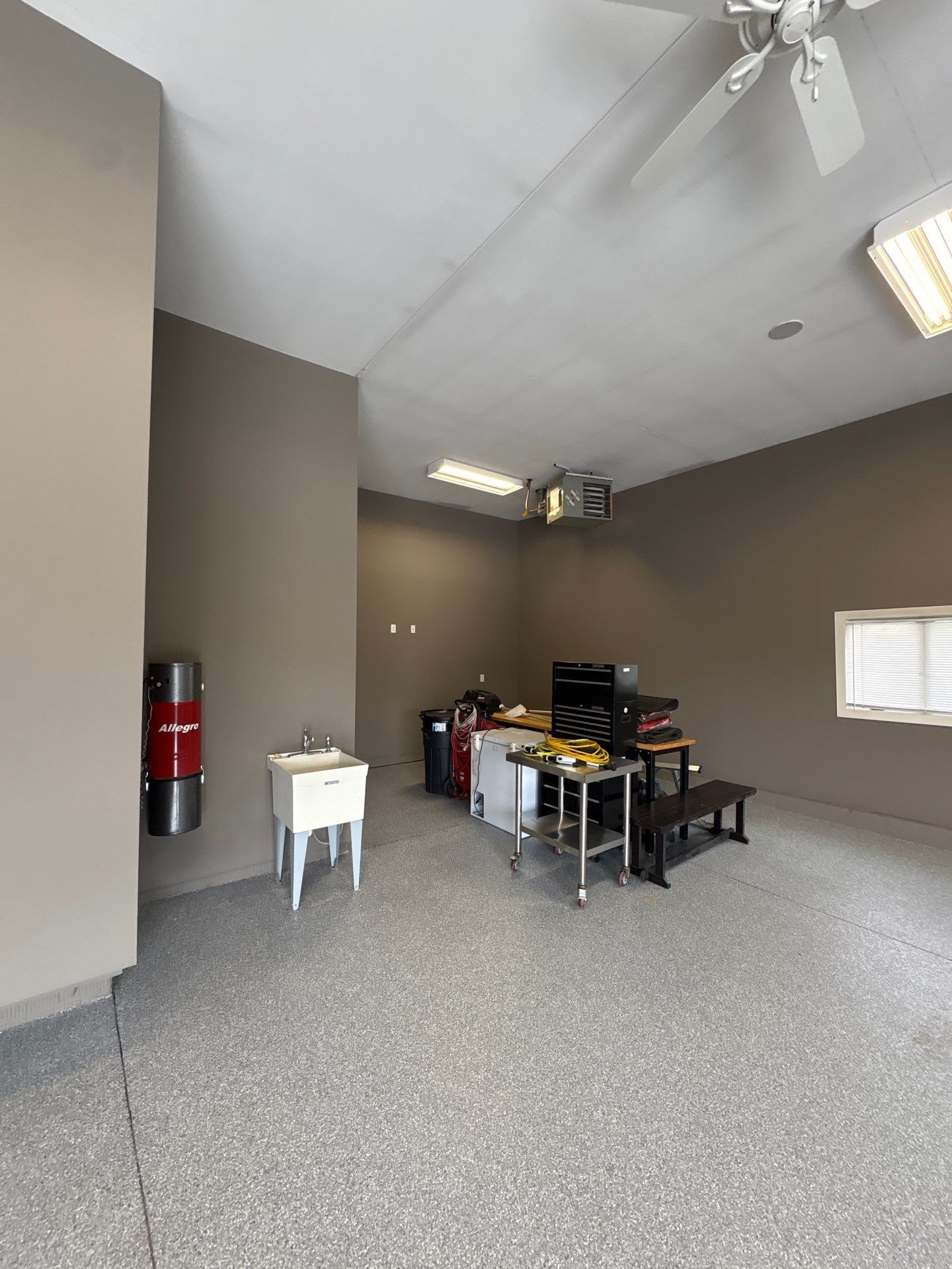 Speckled Grey Epoxy Garage Floor Coating Installation in Tea by Select Painting, Coatings & Garage Cabinets