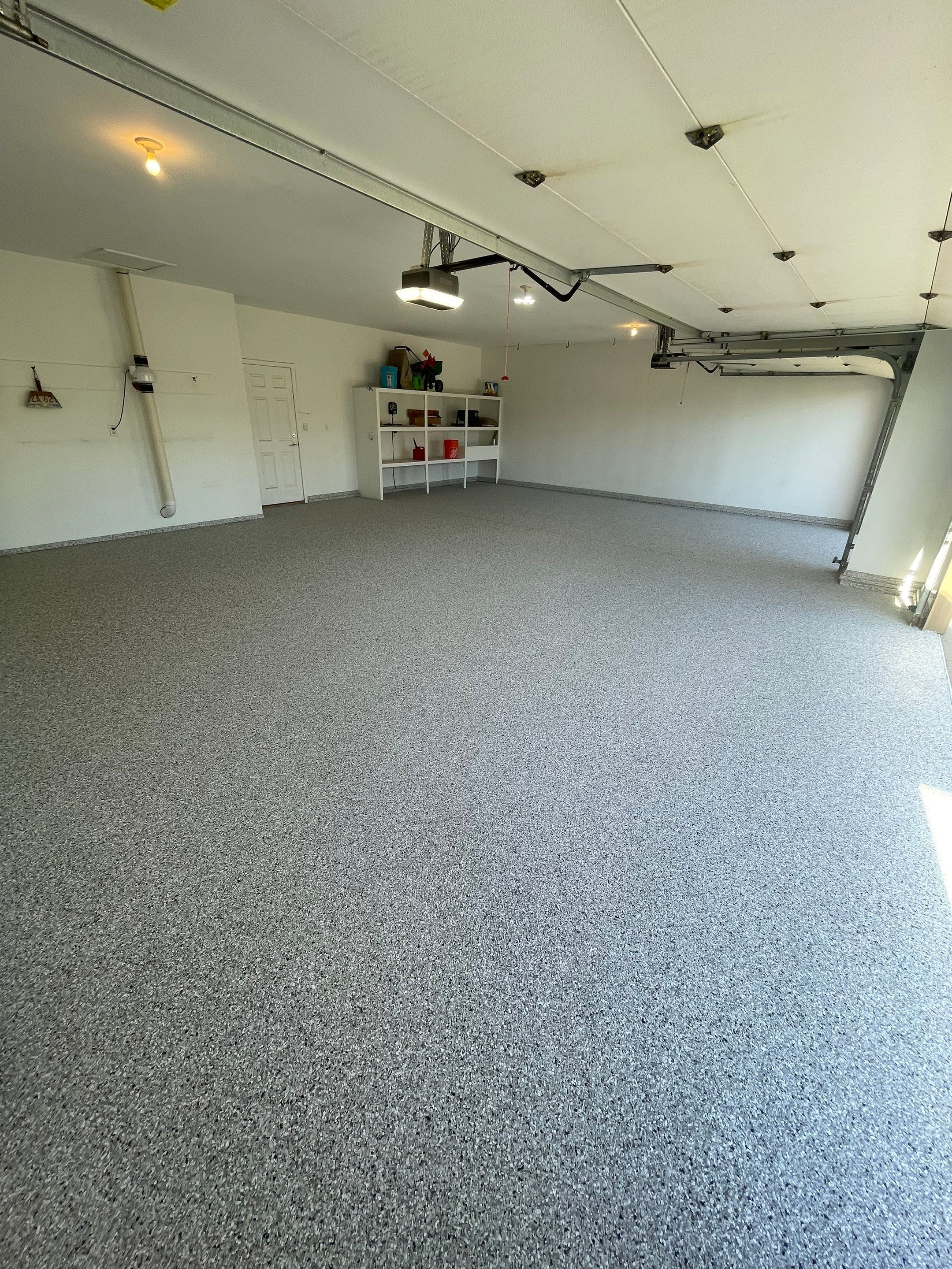 Yankton Garage Floor Restoration with Gray Speckled Epoxy Coating by Select Painting, Coatings & Garage Cabinets