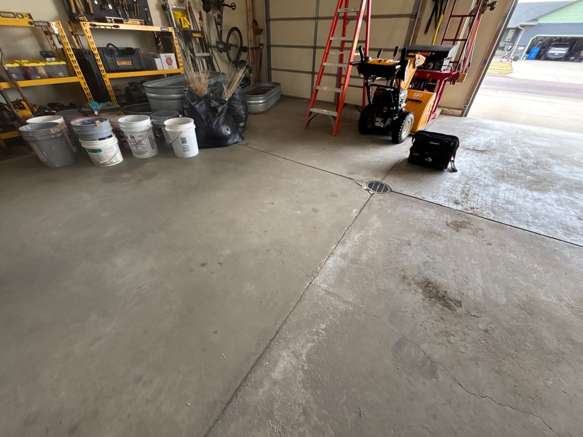 Sioux Falls Garage Floor Repair and Speckled Epoxy Coating Installation by Select Painting, Coatings & Garage Cabinets