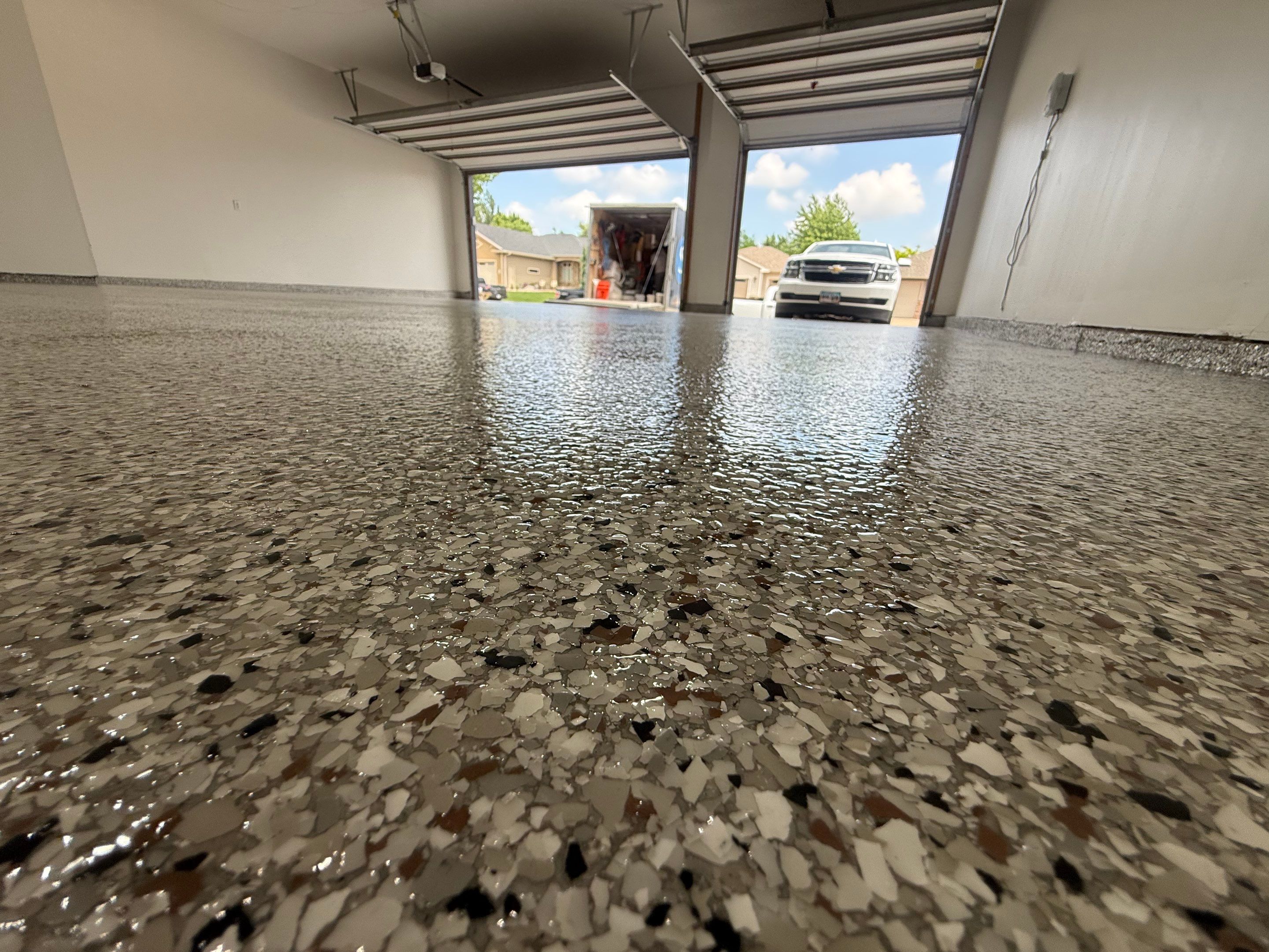 Full Garage Floor Resurfacing and Decorative Epoxy Flake Finish by Select Painting, Coatings & Garage Cabinets