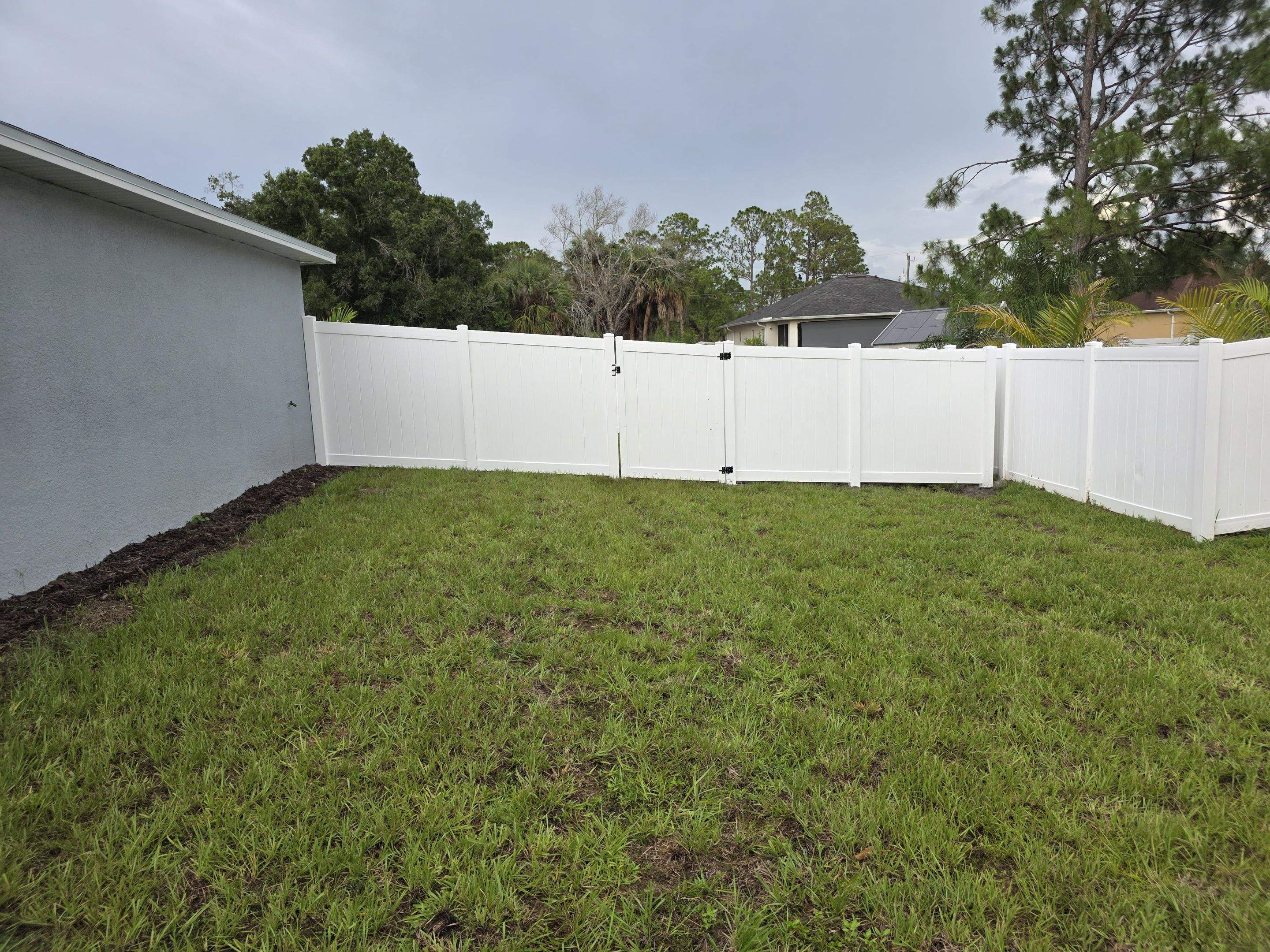 White Vinyl Privacy Fence with Gate Installation in North Port by True Fence LLC