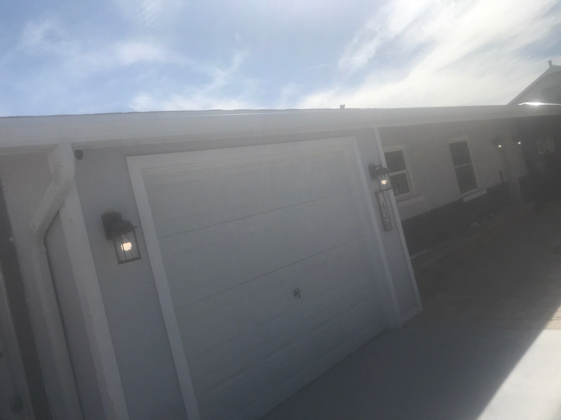 White Seamless Gutters with Matching Downspouts in Fort Myers Beach FL by Gutter Professors