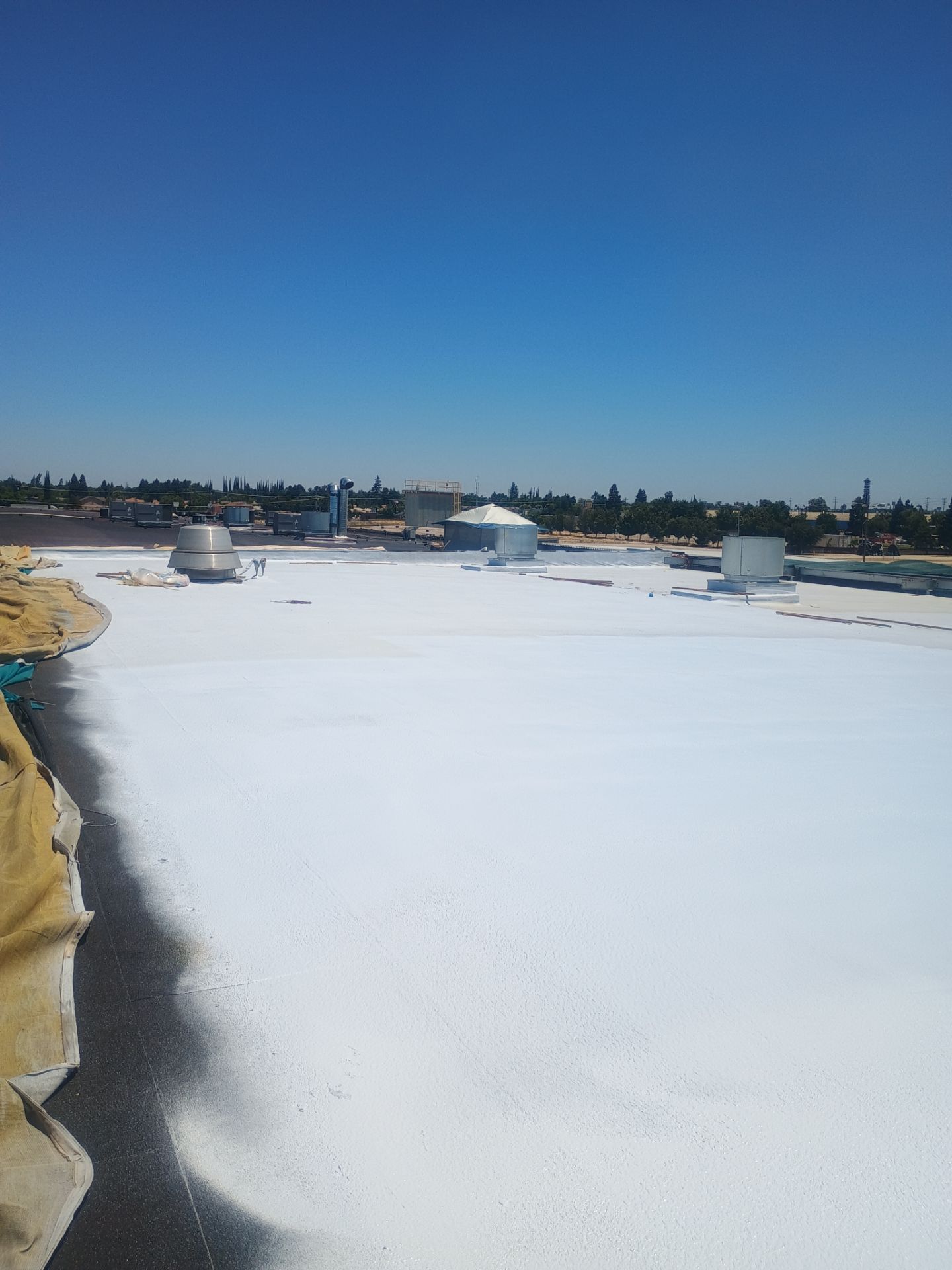Pro Farms Spray foam roofing project by Straight Edge Roofing Inc