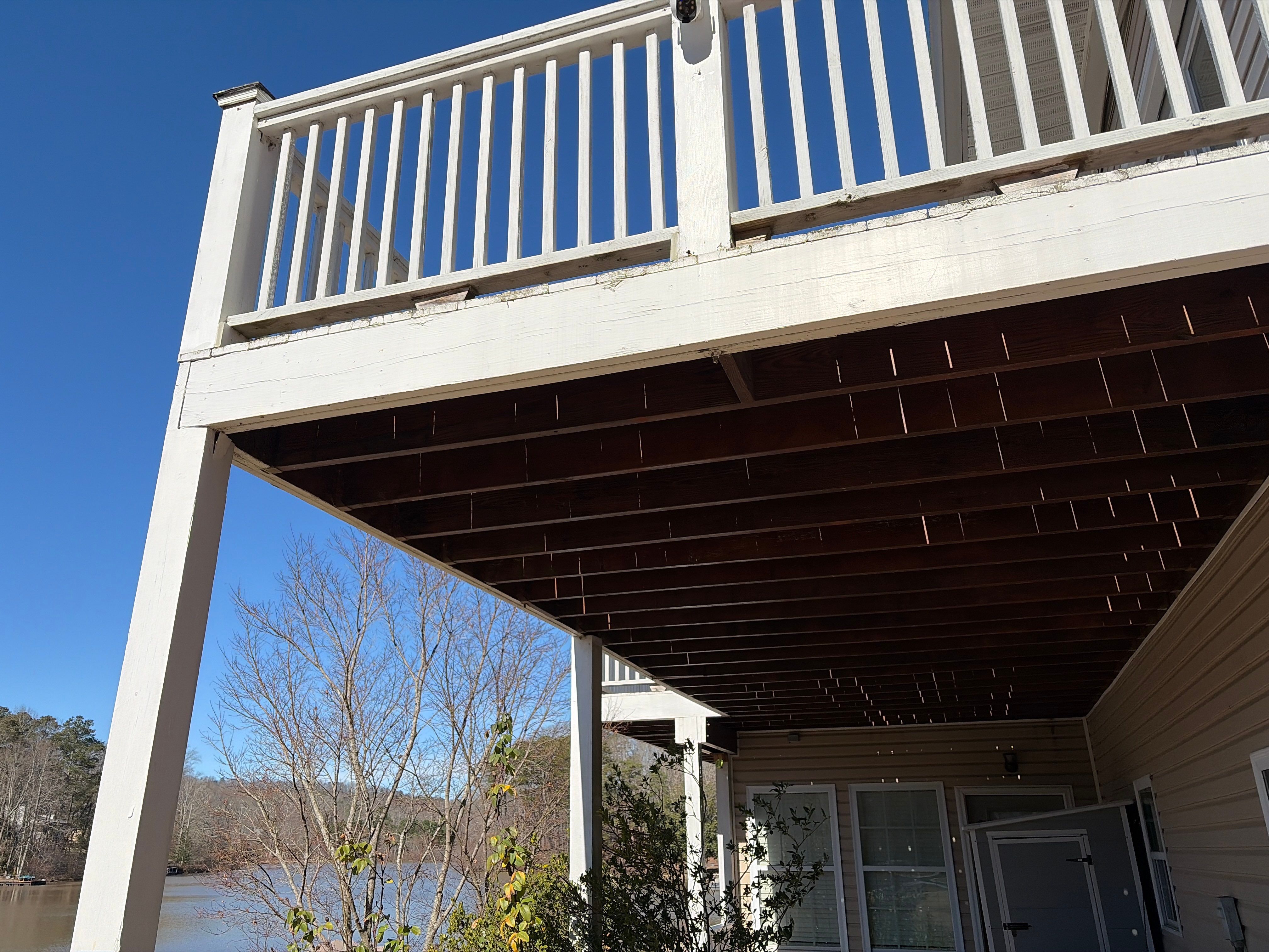 Cumming, GA Lake House Deck Resurface and Extension using Pressure Treated Pine and Skyline Cable Railing by Nelson Exteriors 