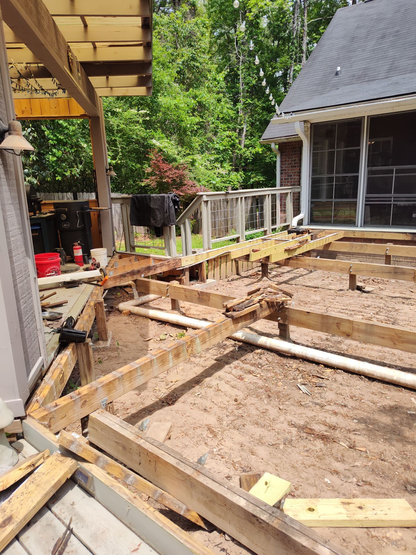 Patio in concrete with drainage improvements by Cornerstone Home Builders, LLC