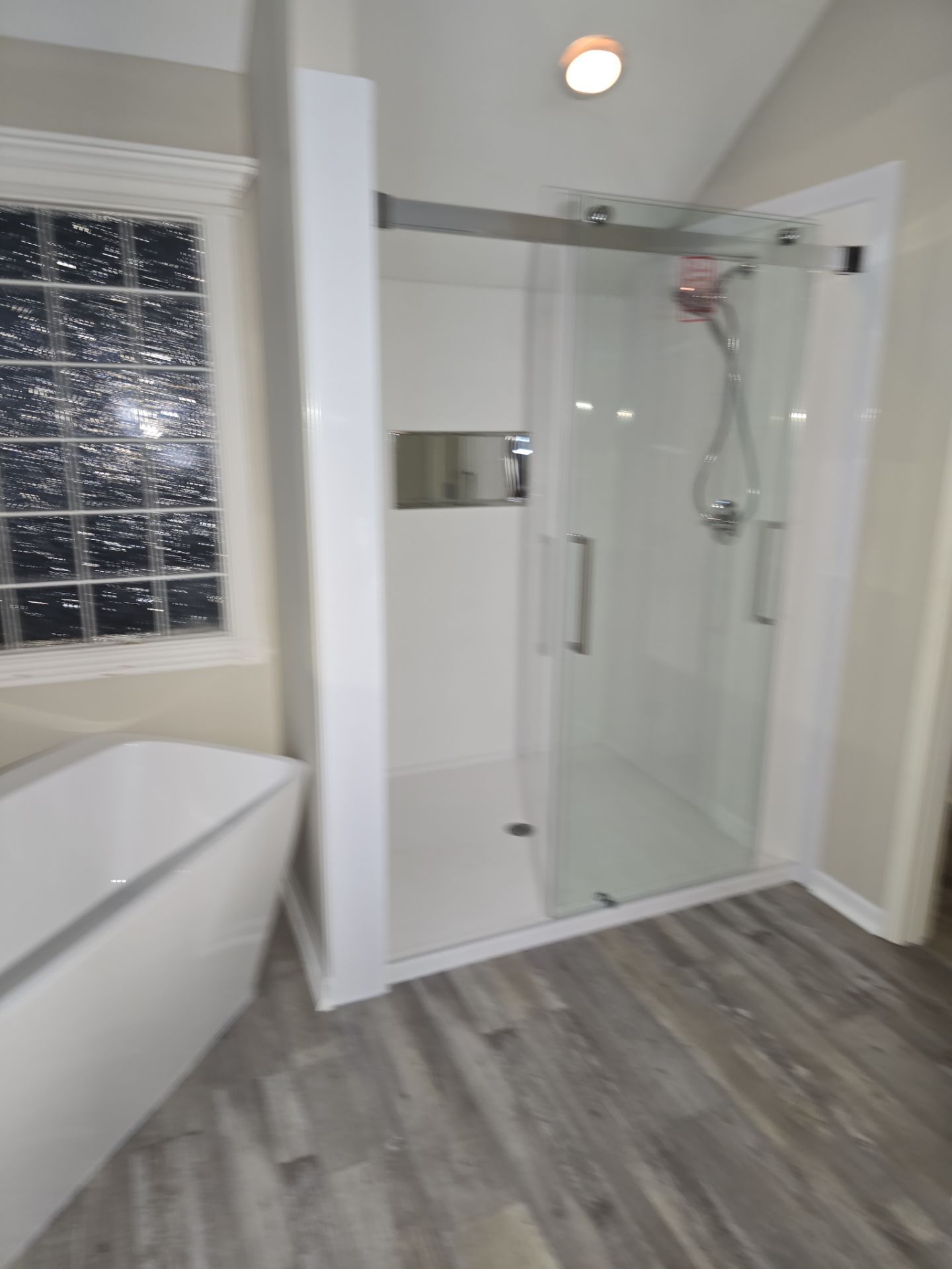 Full bathroom remodel with Artus lighted mirrors, Waltz bathtub and Mercury doors by The Shower Company