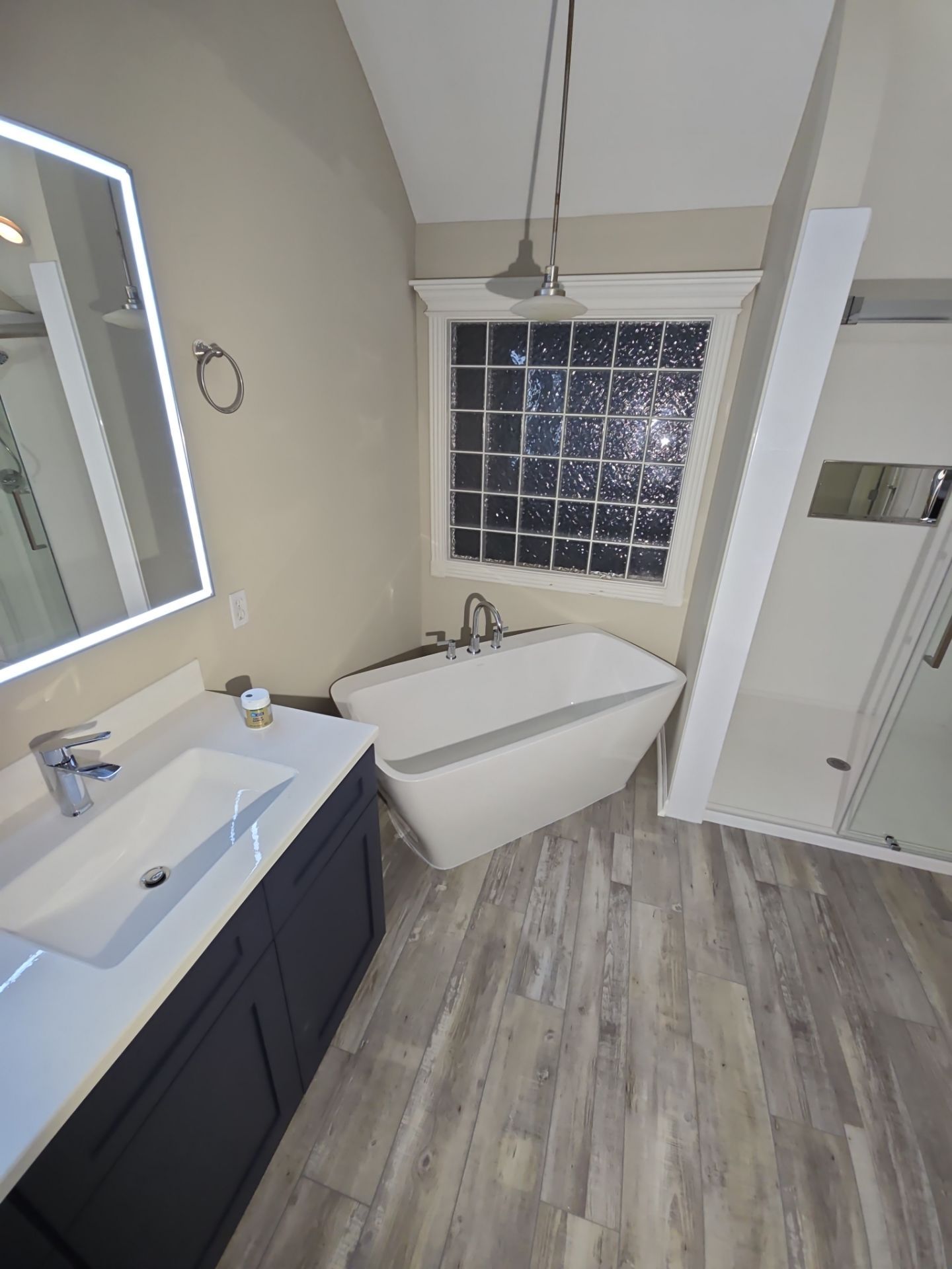 Full bathroom remodel with Artus lighted mirrors, Waltz bathtub and Mercury doors by The Shower Company