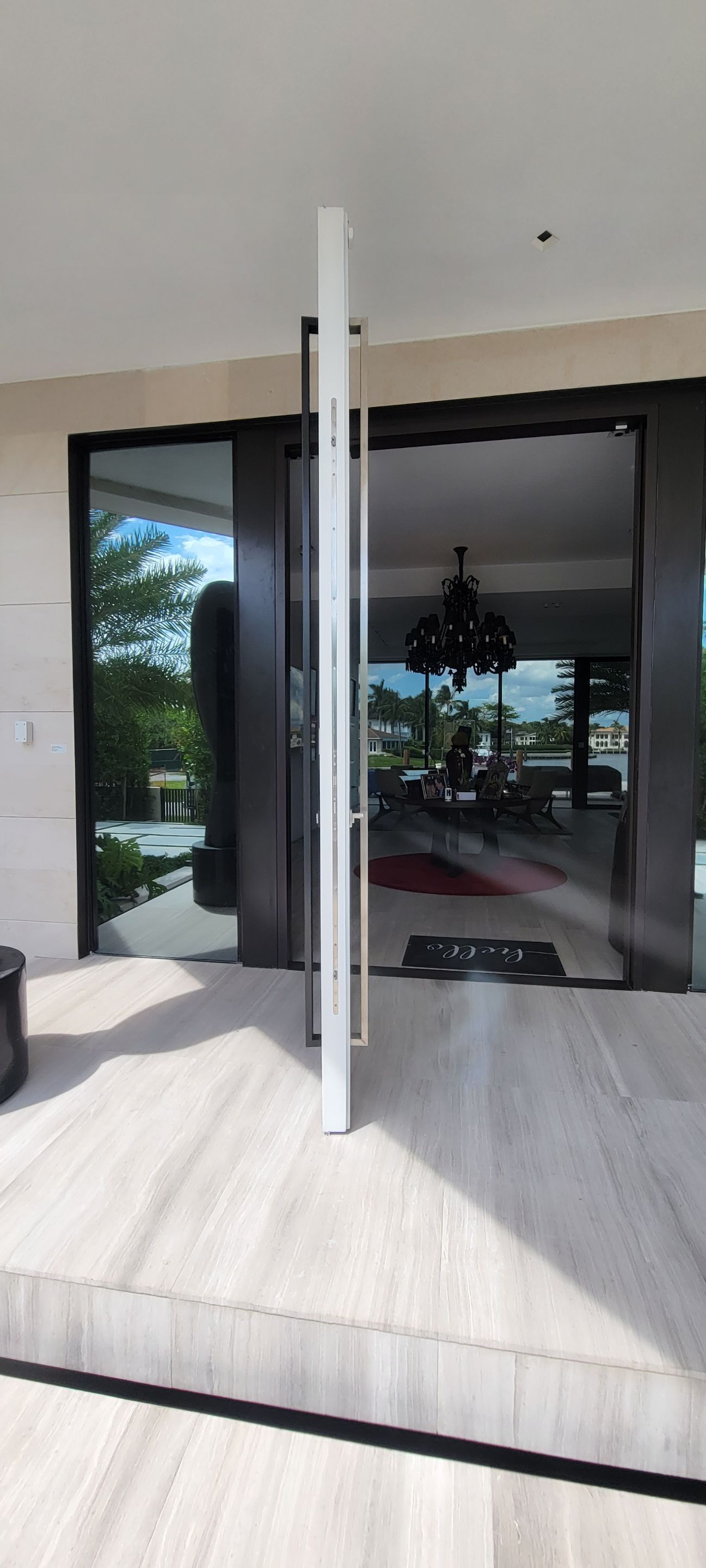 Custom Material Pivot Door installation by Impact Precious Wood Inc.