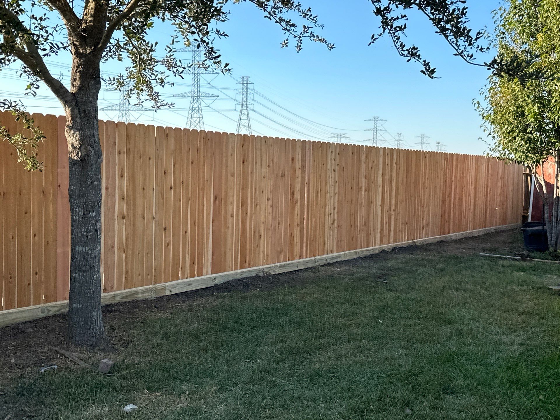 Beautiful Wood fence with metal posts by Tim's Fences