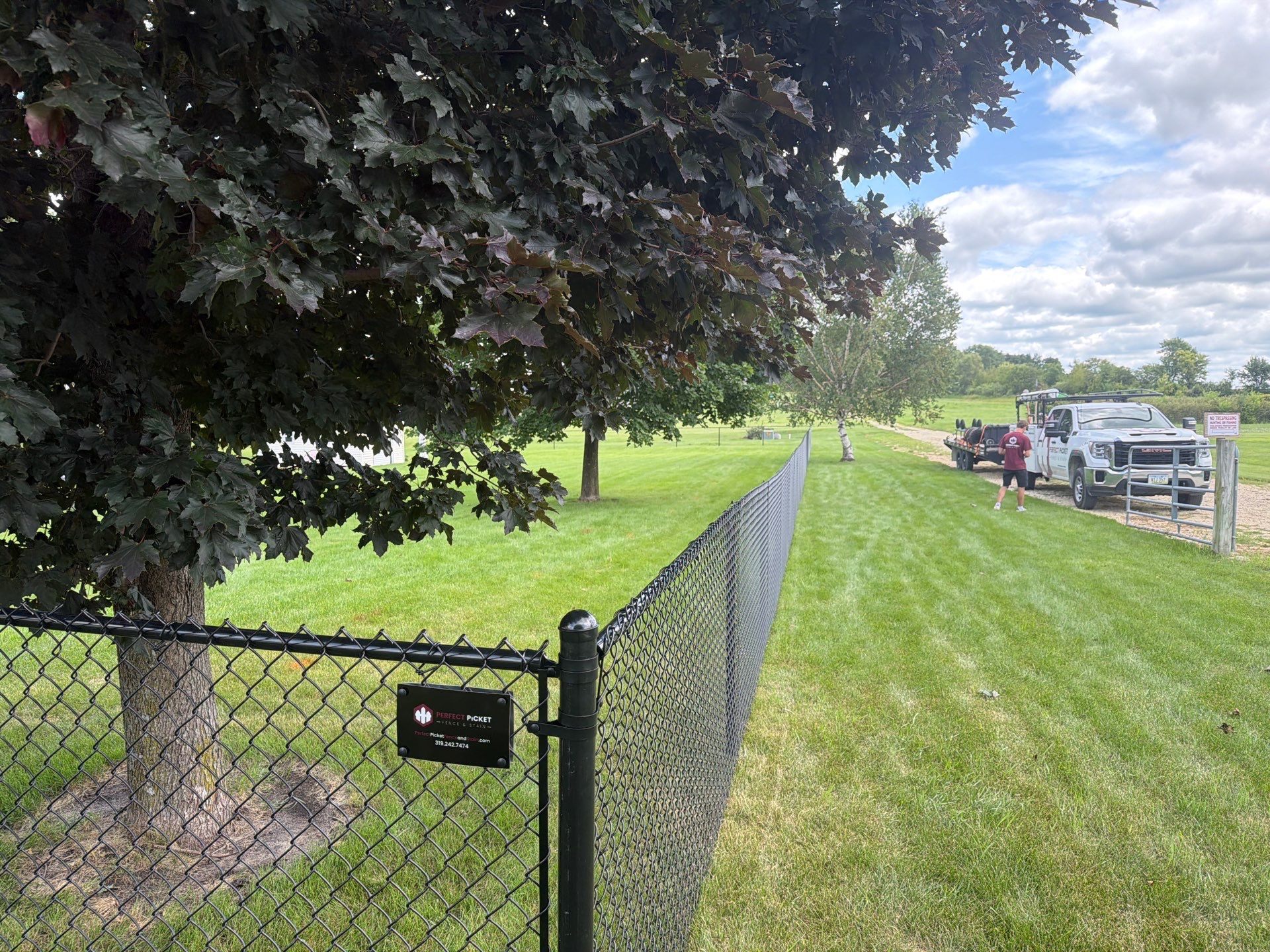 Black Vinyl-Coated Chain Link Fence Installation in Fairbank by Perfect Picket Fence and Stain