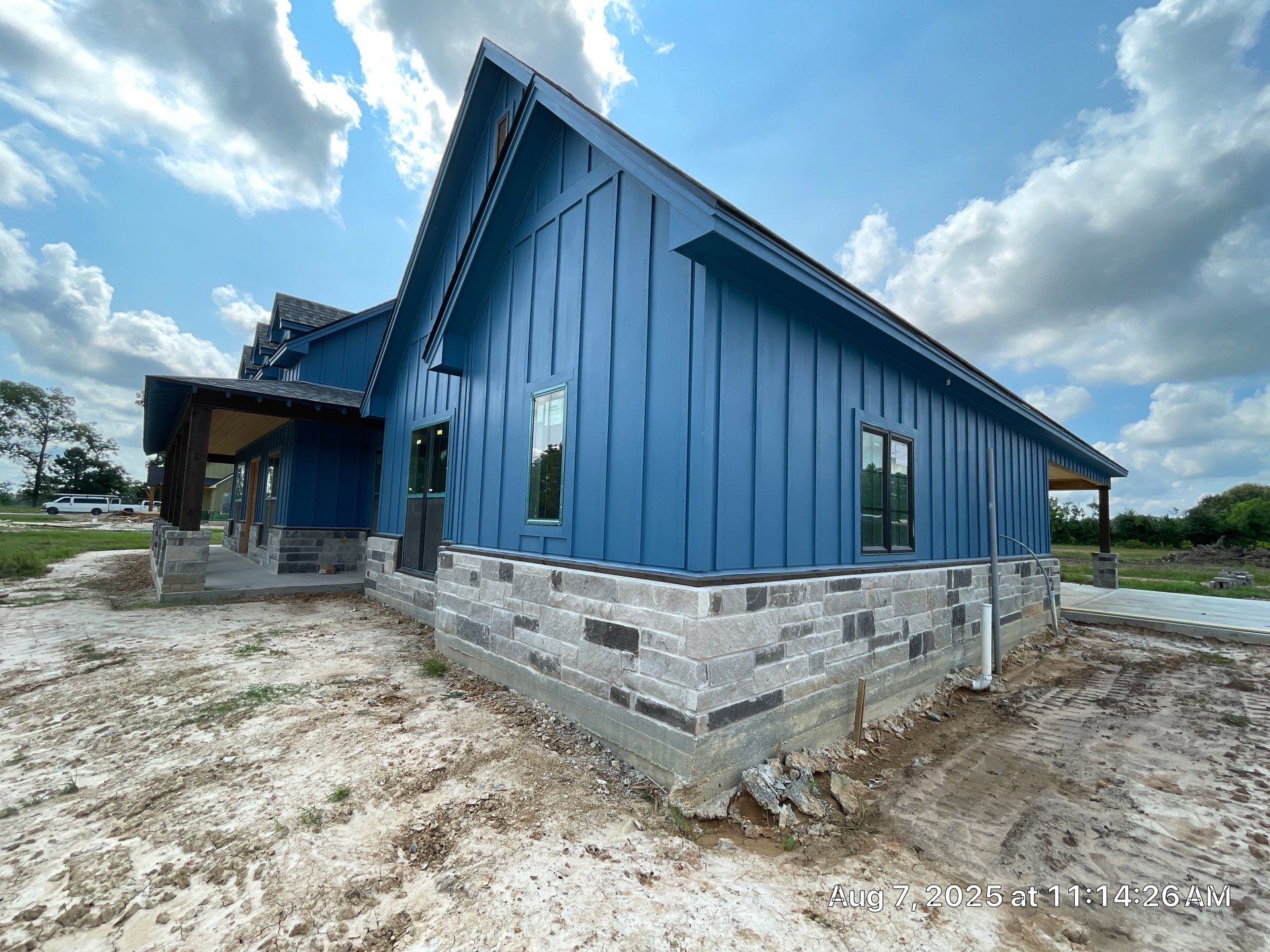 Natural Stone Elegance: Apex Installation Accented by Blue Siding by Apex Conventional Stucco Llc