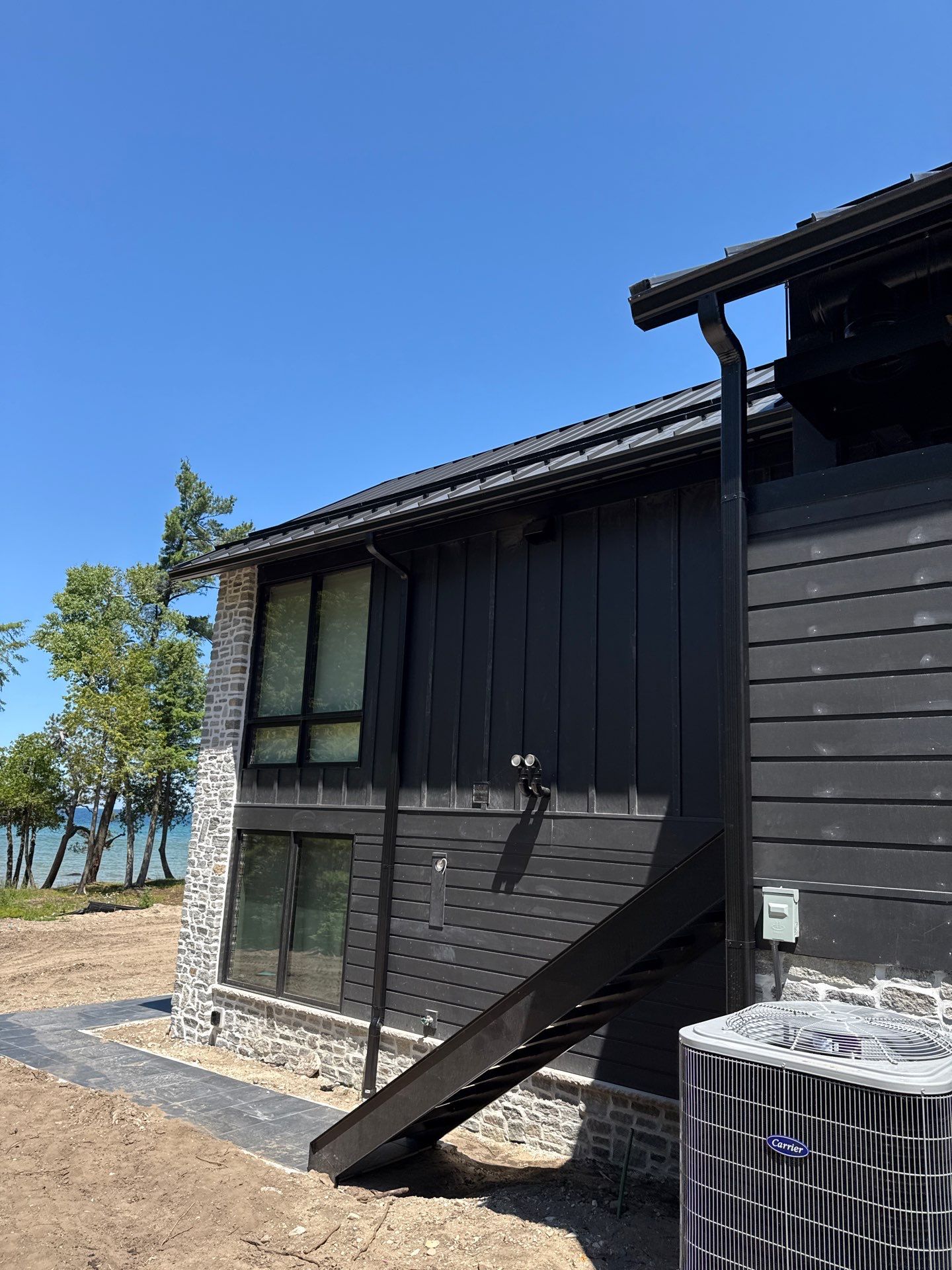 Gutter and Drainage System Installation for Modern Residential Build by Rainbow Seamless Systems