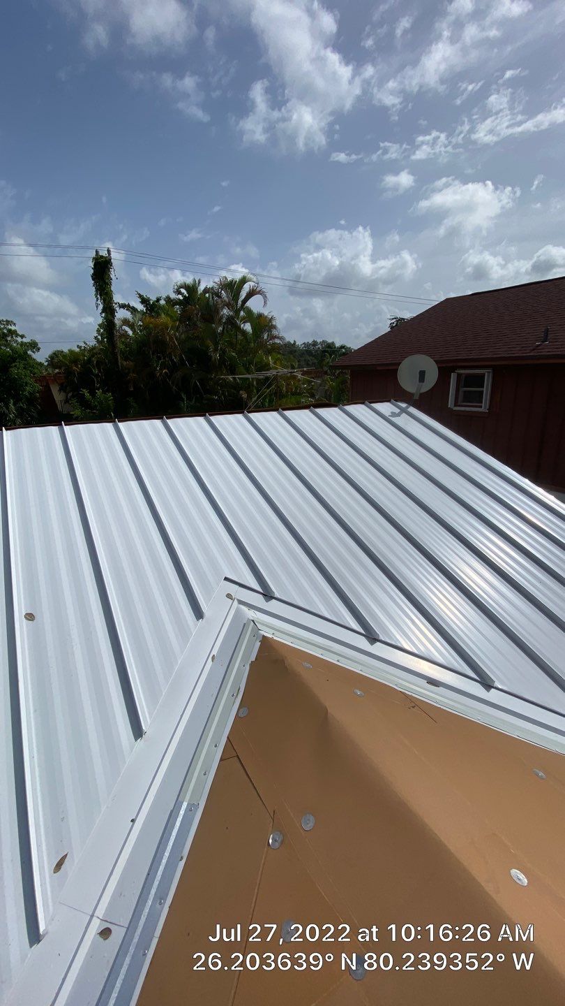 Residential Roofing Installation using 1.5" Nail Strip 24ga Solar White Kynar Coated Standing Seam Metal Panels by Morton Roofing, Inc.