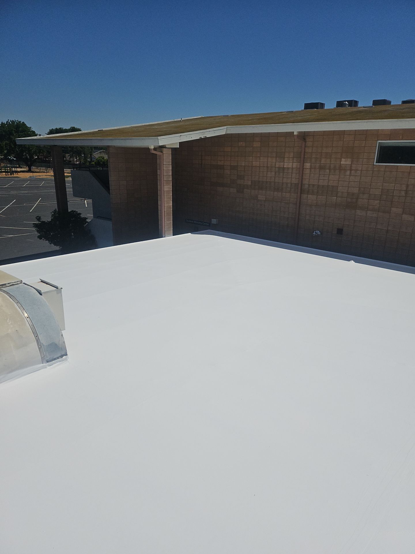 Single-ply restoration system using Benchmark/PUMA XL coatings over TPO single-ply roofing by Straight Edge Roofing Inc