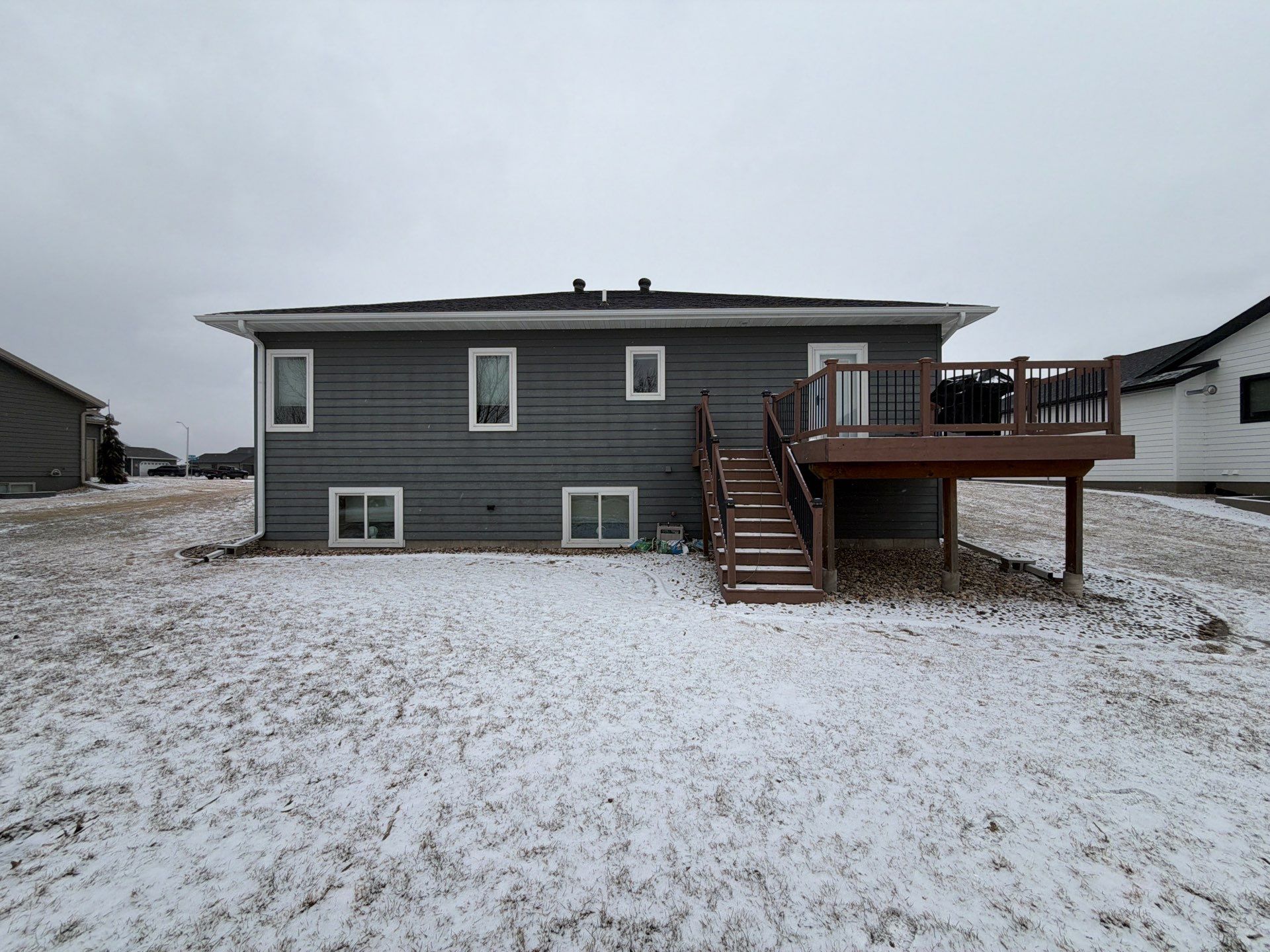 Madison Exterior Remodel with Dark Gray Siding and Stone Accents by Select Painting, Coatings & Garage Cabinets