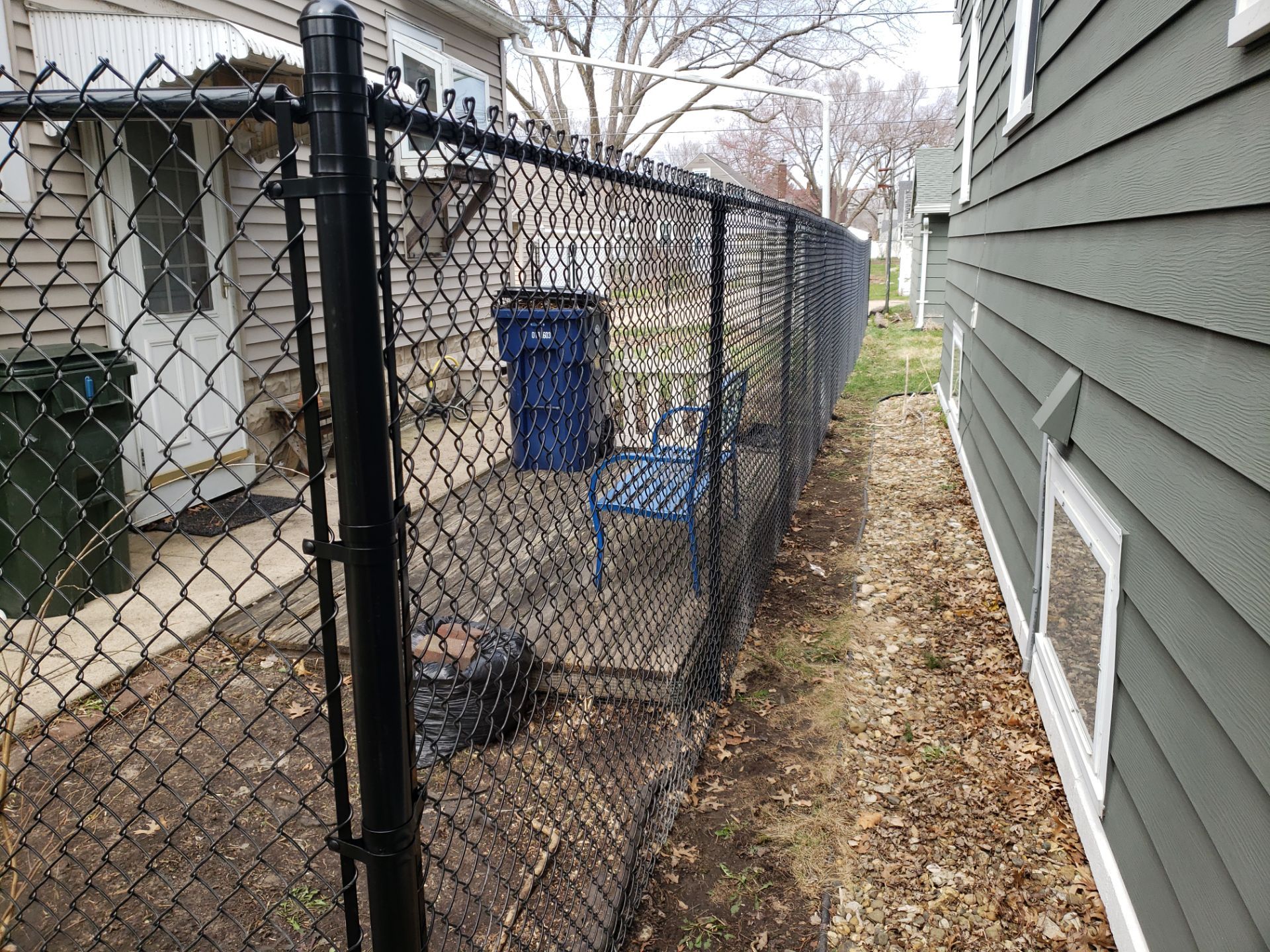 Black Vinyl Coated Chain Link Fence Installation in Waterloo by Perfect Picket Fence and Stain