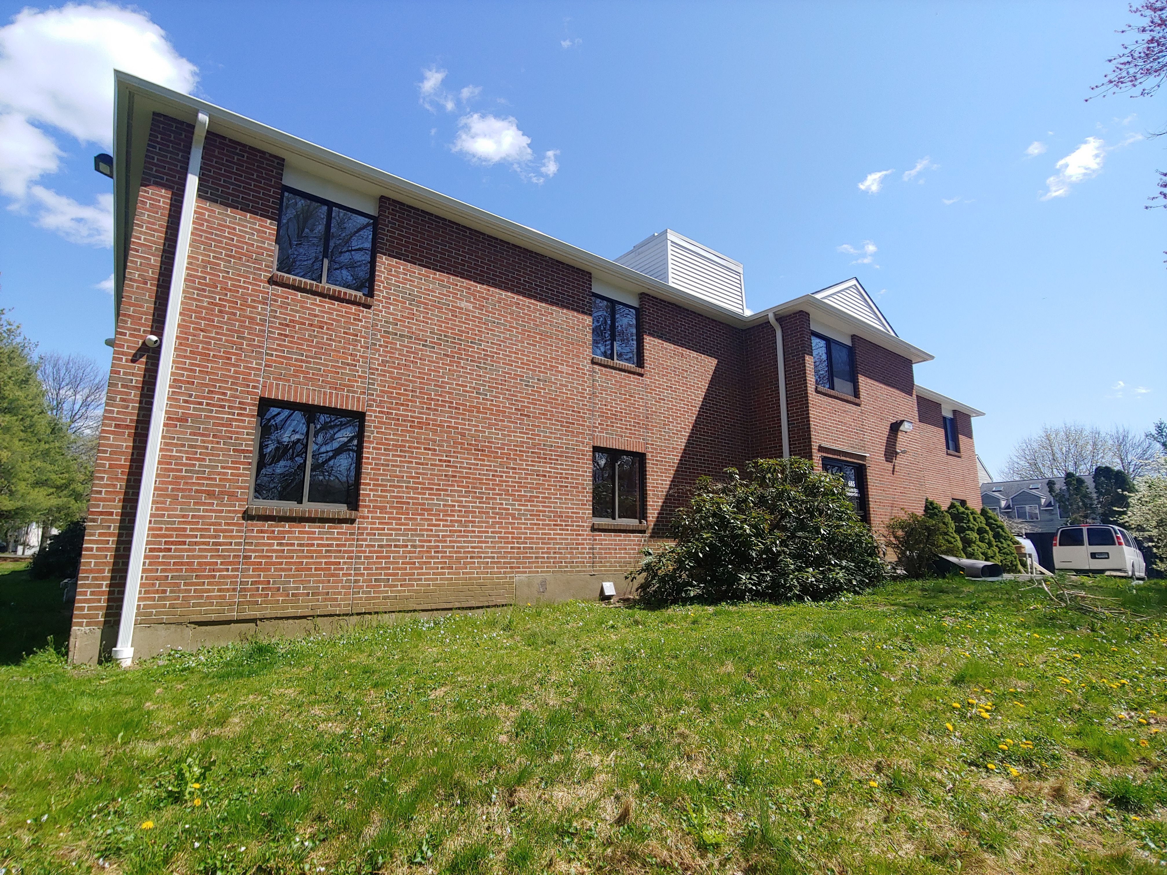 Commercial Roofing Installation using EPDM with white gutters by A Plus Exterior