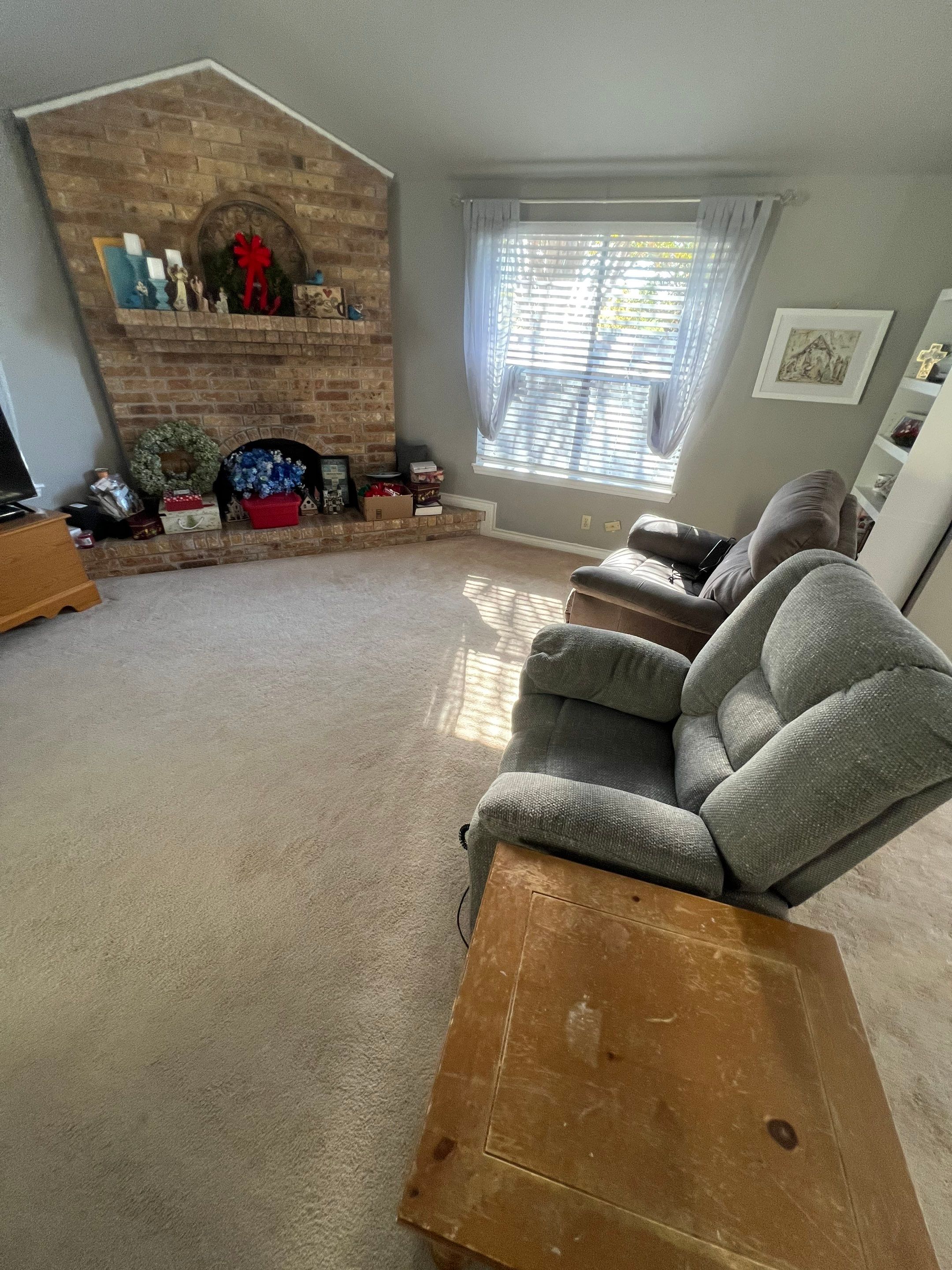 carpet cleaning is being done on the light colored carpet in the living room space