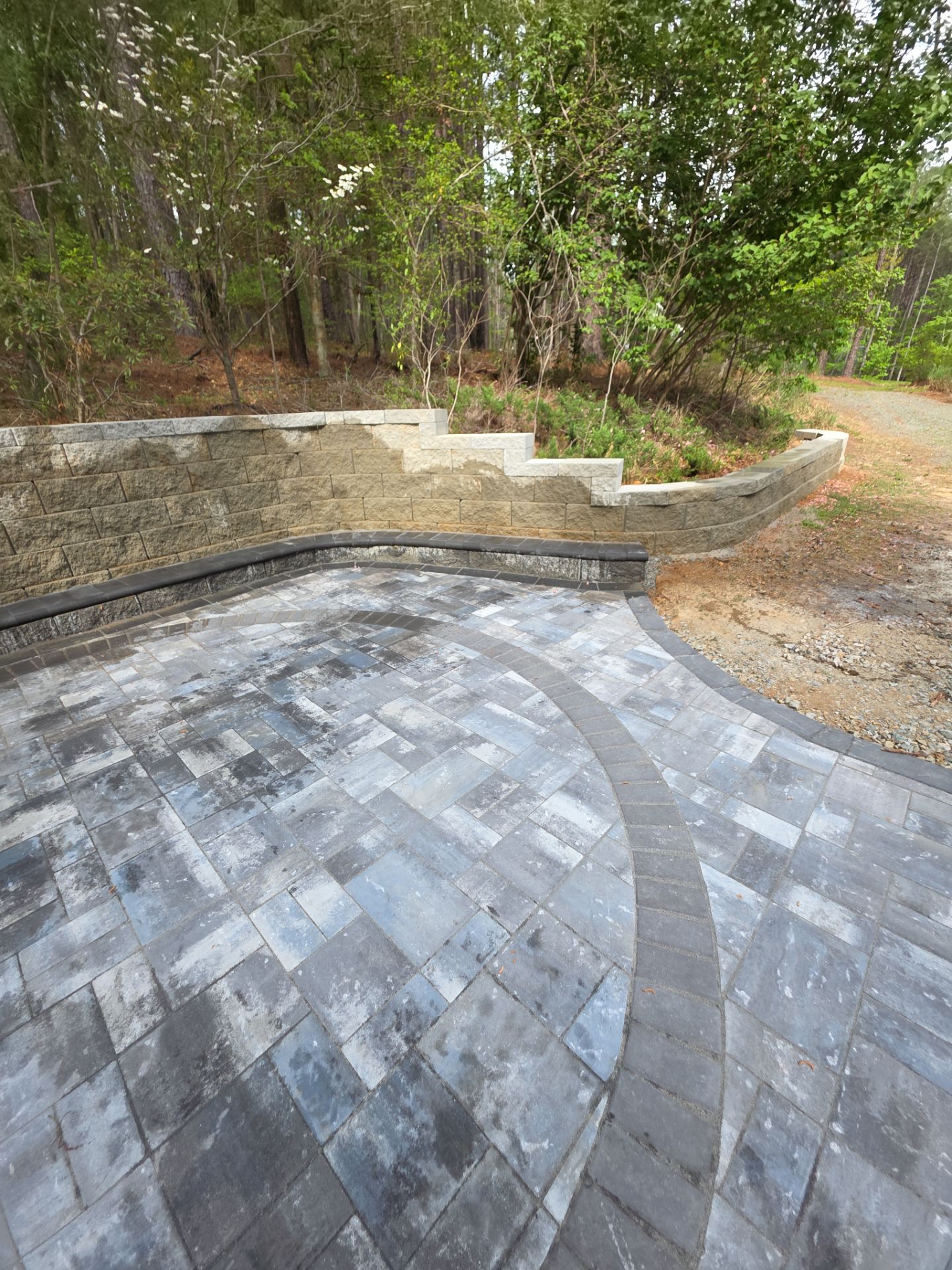 Pittsboro Outdoor Living Transformation – Retaining Wall, Paver Patio & Elevated Deck by Elite Remodeling and Design LLC