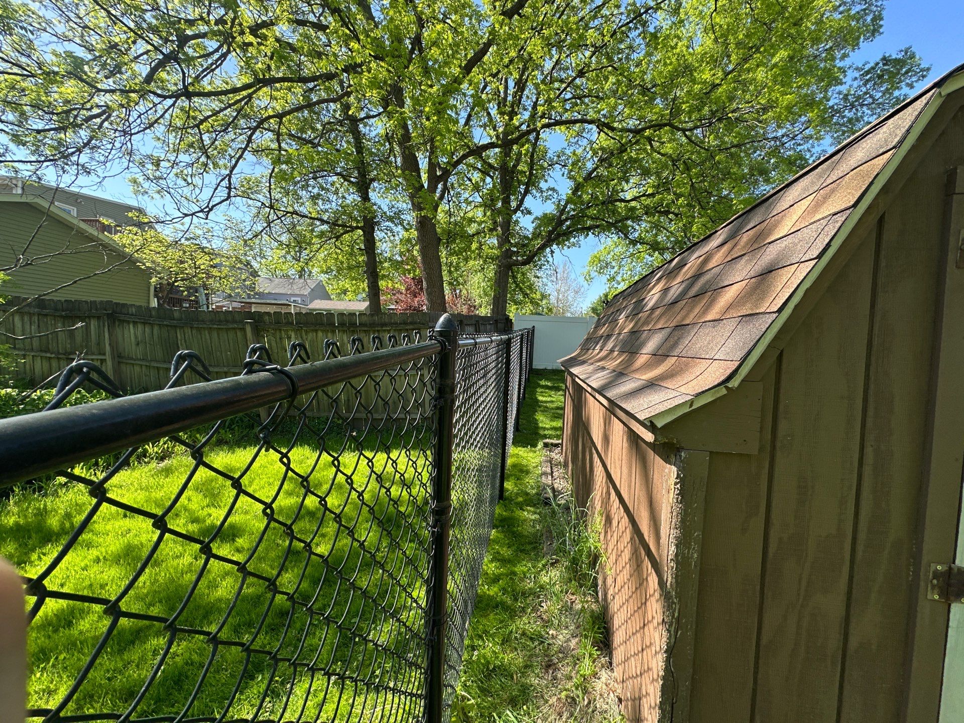 Black Chain Link Fence and Driveway Gate Installation in Waterloo by Perfect Picket Fence and Stain