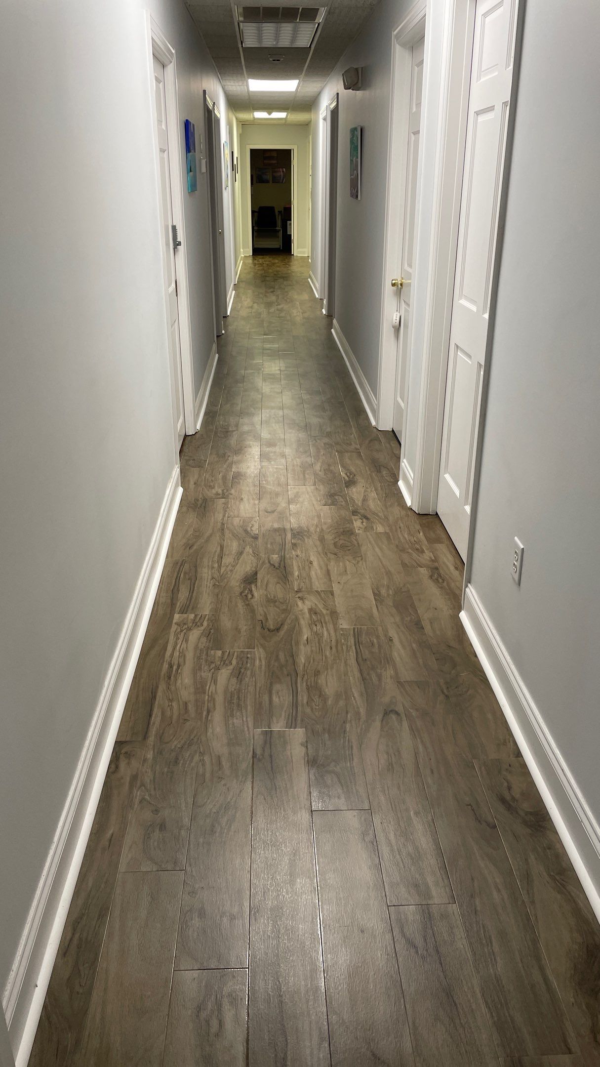 Office Remodel from Worn Out Carpet to Sleek Glued Down LVP by Footprints Floors of Coastal Carolina