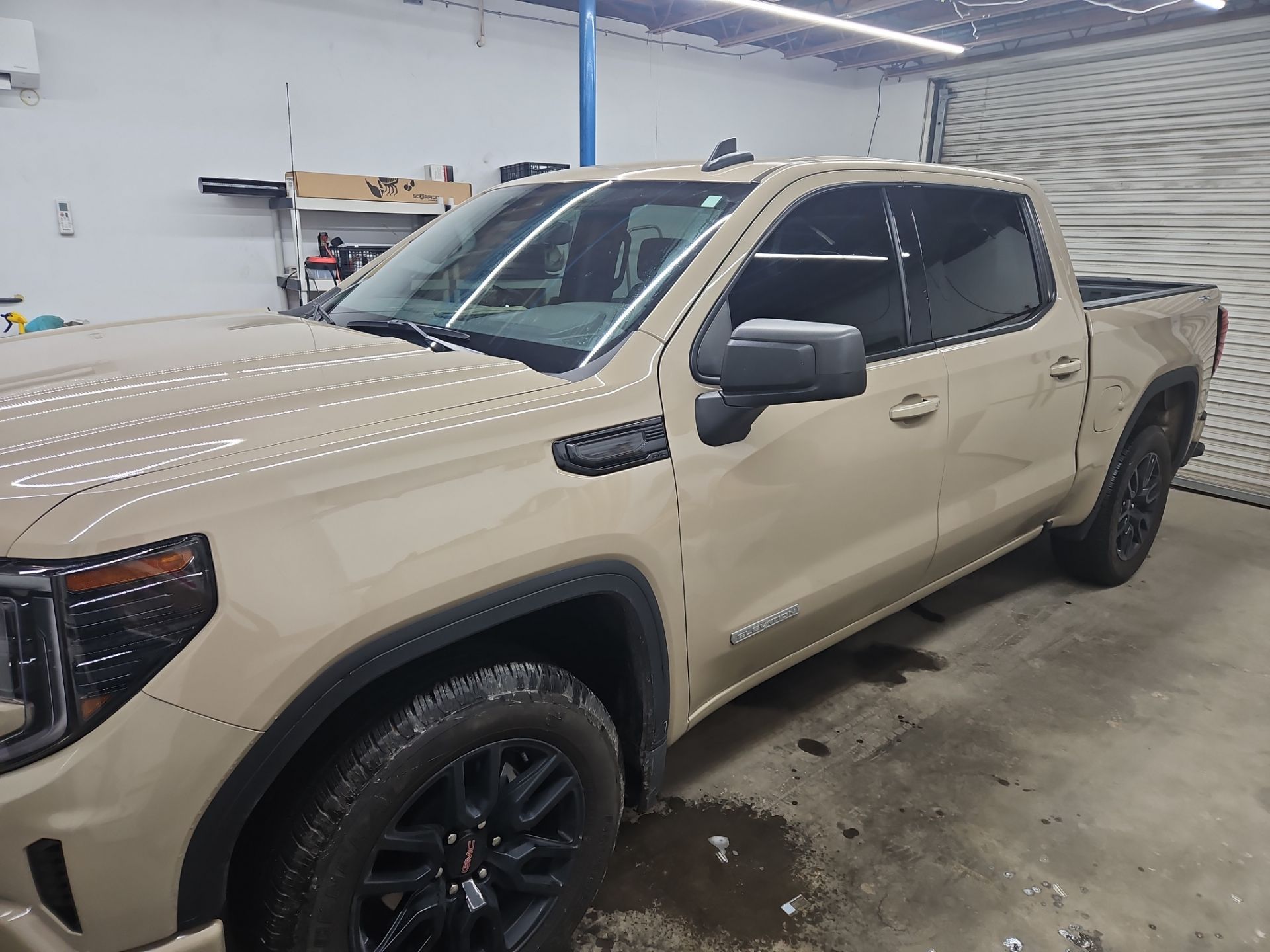 the service being done is applying window tint to a beige pickup truck the tint is installed on the front and rear side windows enhancing privacy and reducing glare the vehicle appears to be in a clean and professional environment suggesting that proper care is taken during the installation process