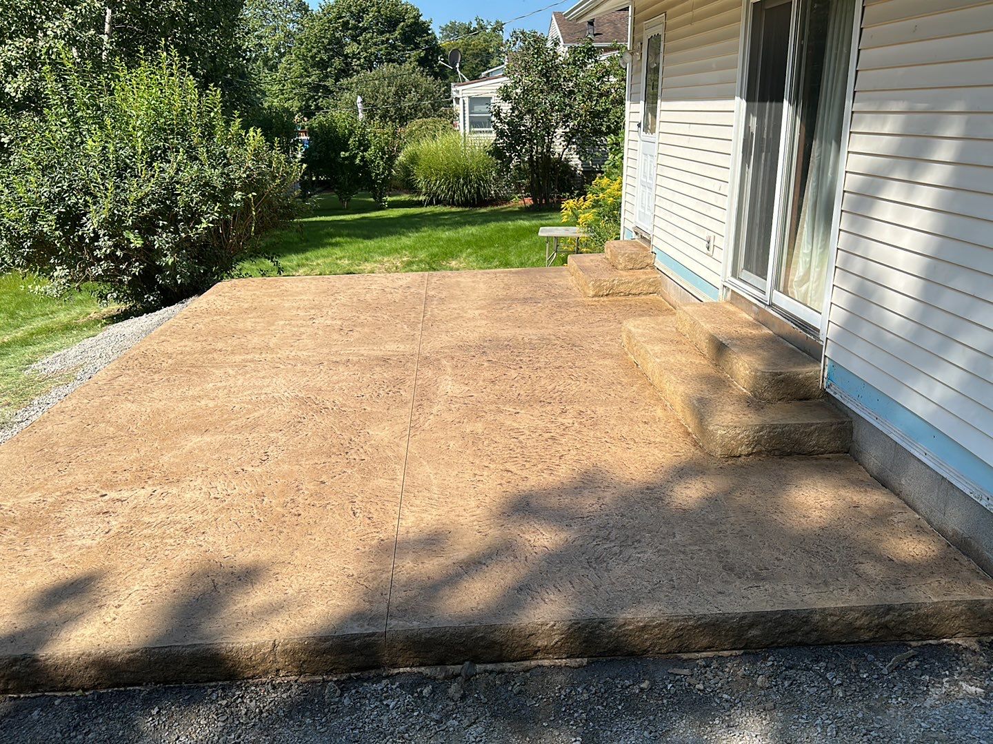 Bluestone textured stamped concrete patio by NG Masonry & Construction LLC