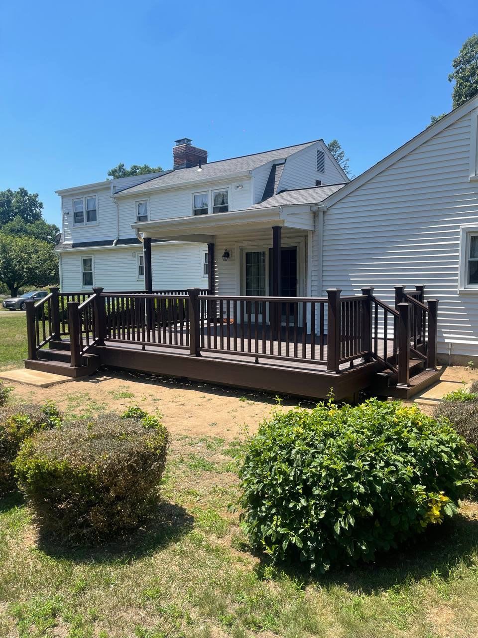New deck using Trex Tropical Lava rock, Transcend railings in Vintage Lantern with matching fascia. by DiGiorgi Roofing and Siding Inc