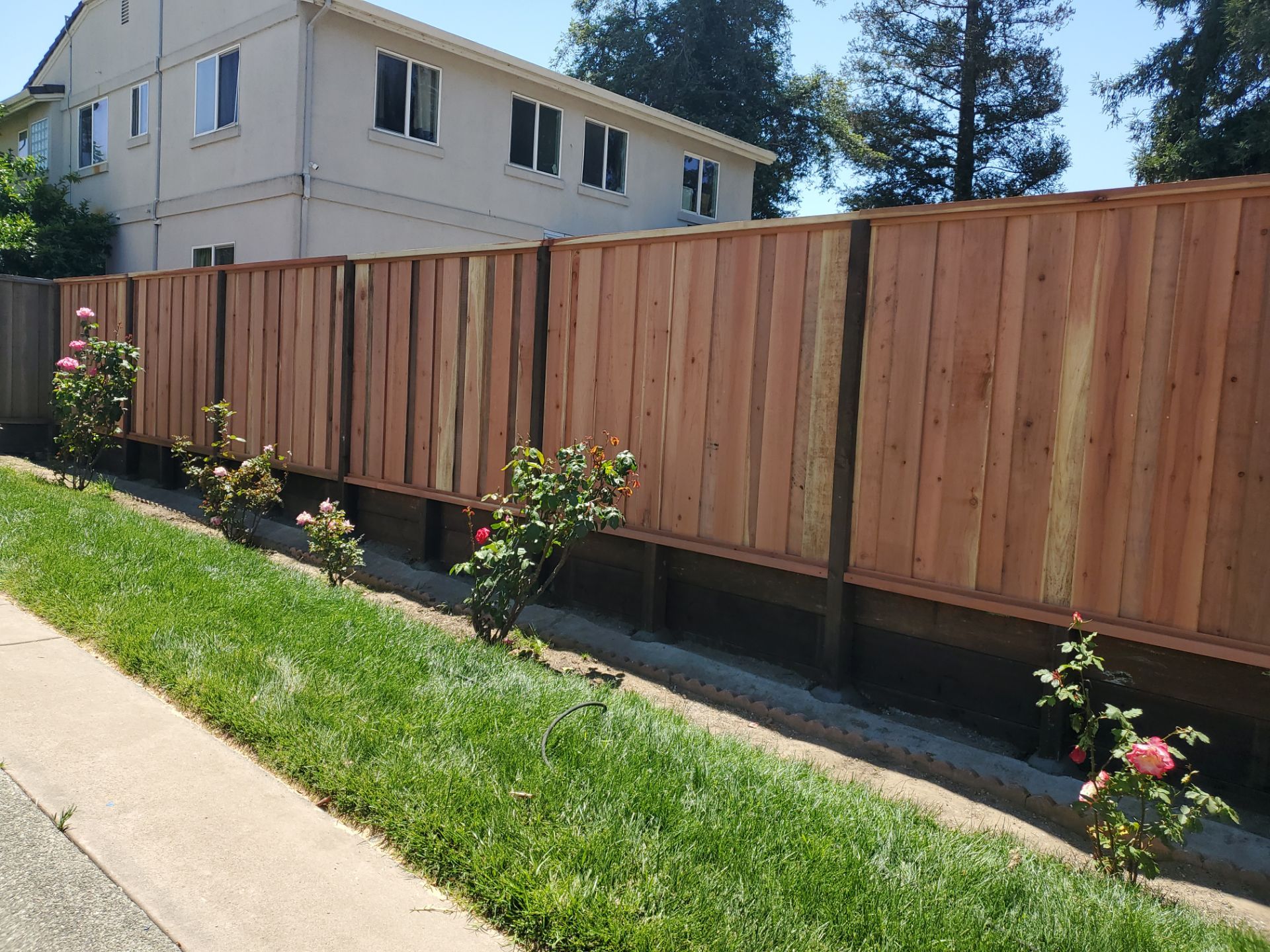 Board on Board - 8' High with 2' Retaining Wall by Fremont Fence Inc
