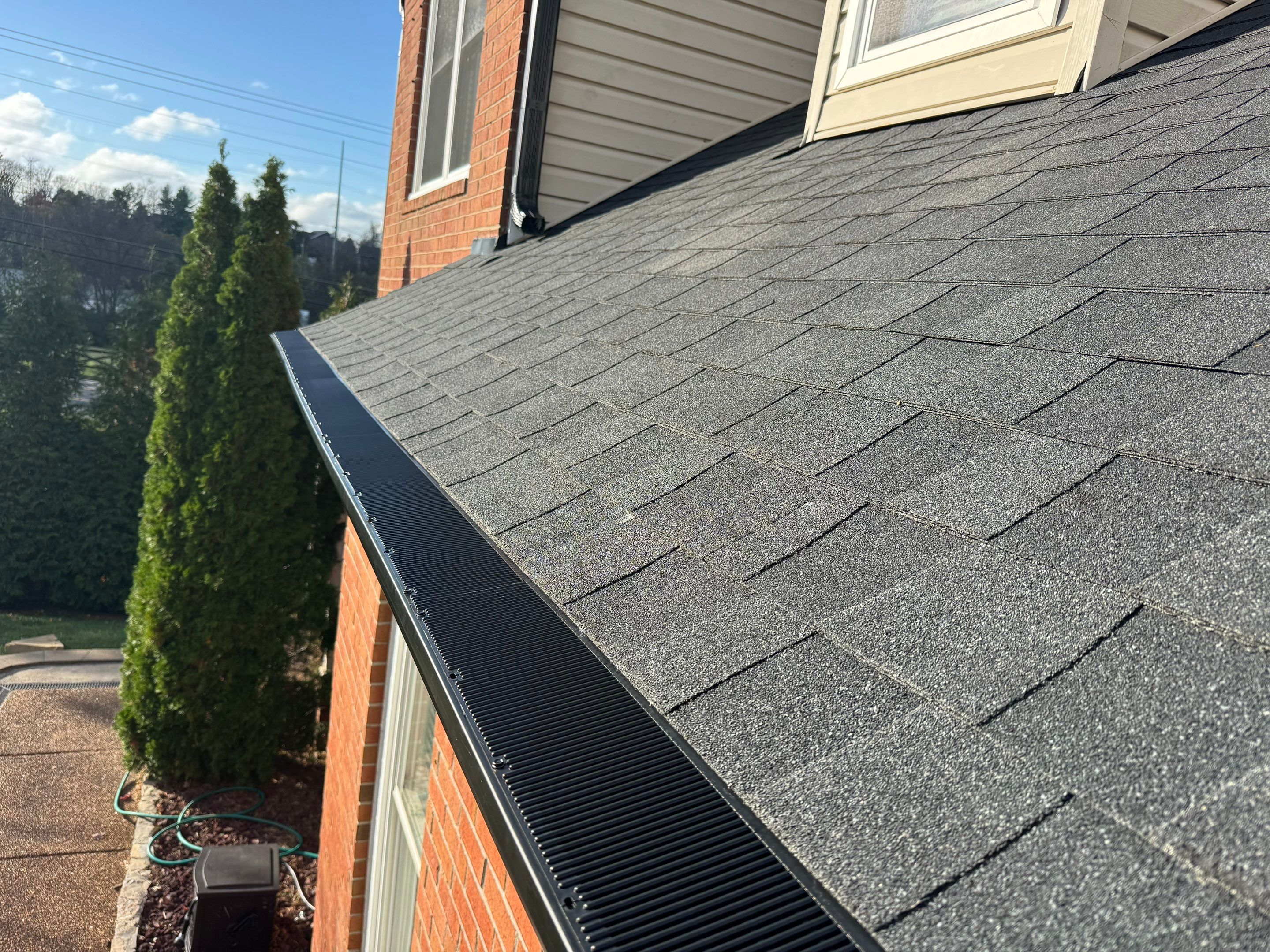 Charcoal Black Re-Roof & Gutters by Royal House LLC