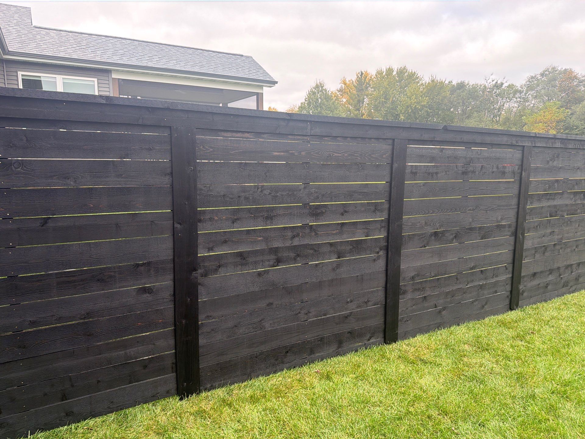 Modern Horizontal Wood Privacy Fence Installation in Cedar Falls by Perfect Picket Fence and Stain