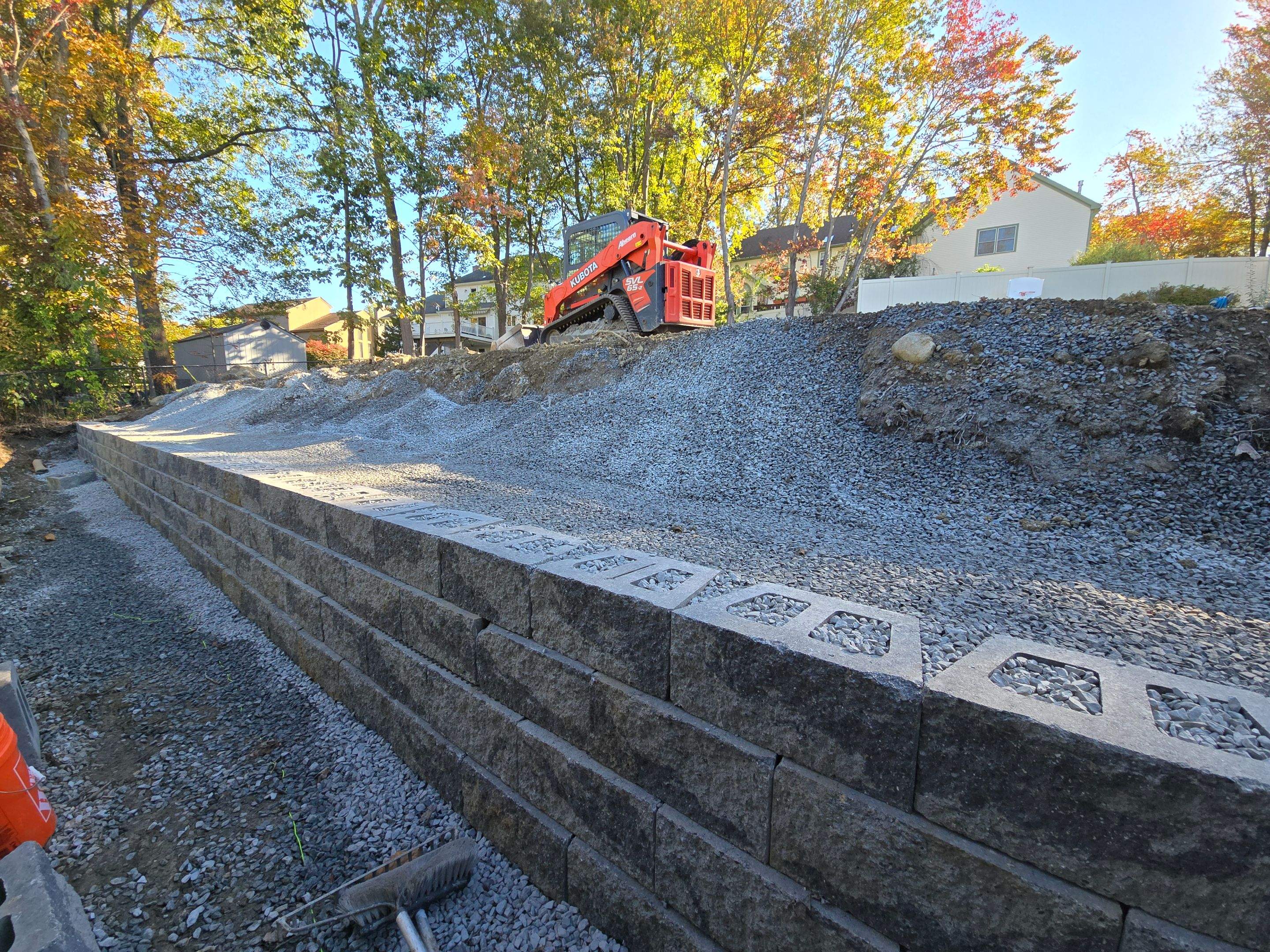 Retaining Wall to Level Backyard  by May Property Management 
