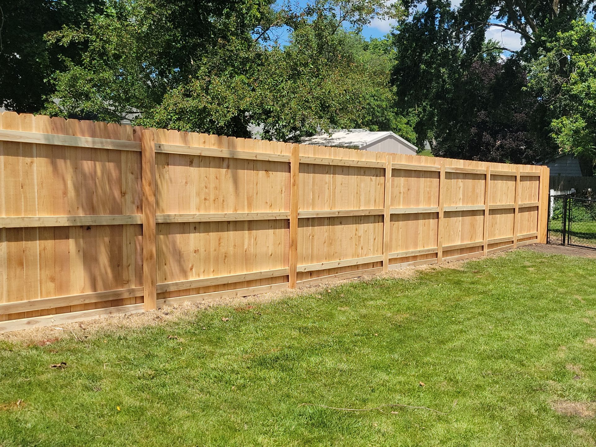 Custom Cedar Unstained Wood Privacy Fence Installation in Cedar Falls by Perfect Picket Fence and Stain