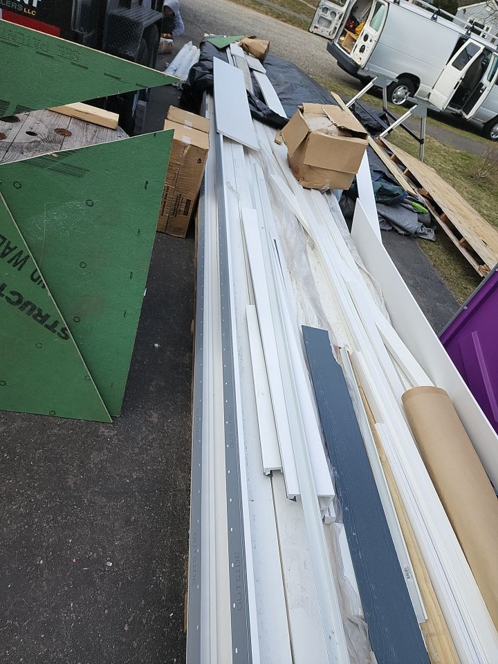 James Hardie siding, new metal roof and couple windows being installed. by UBrothers Construction